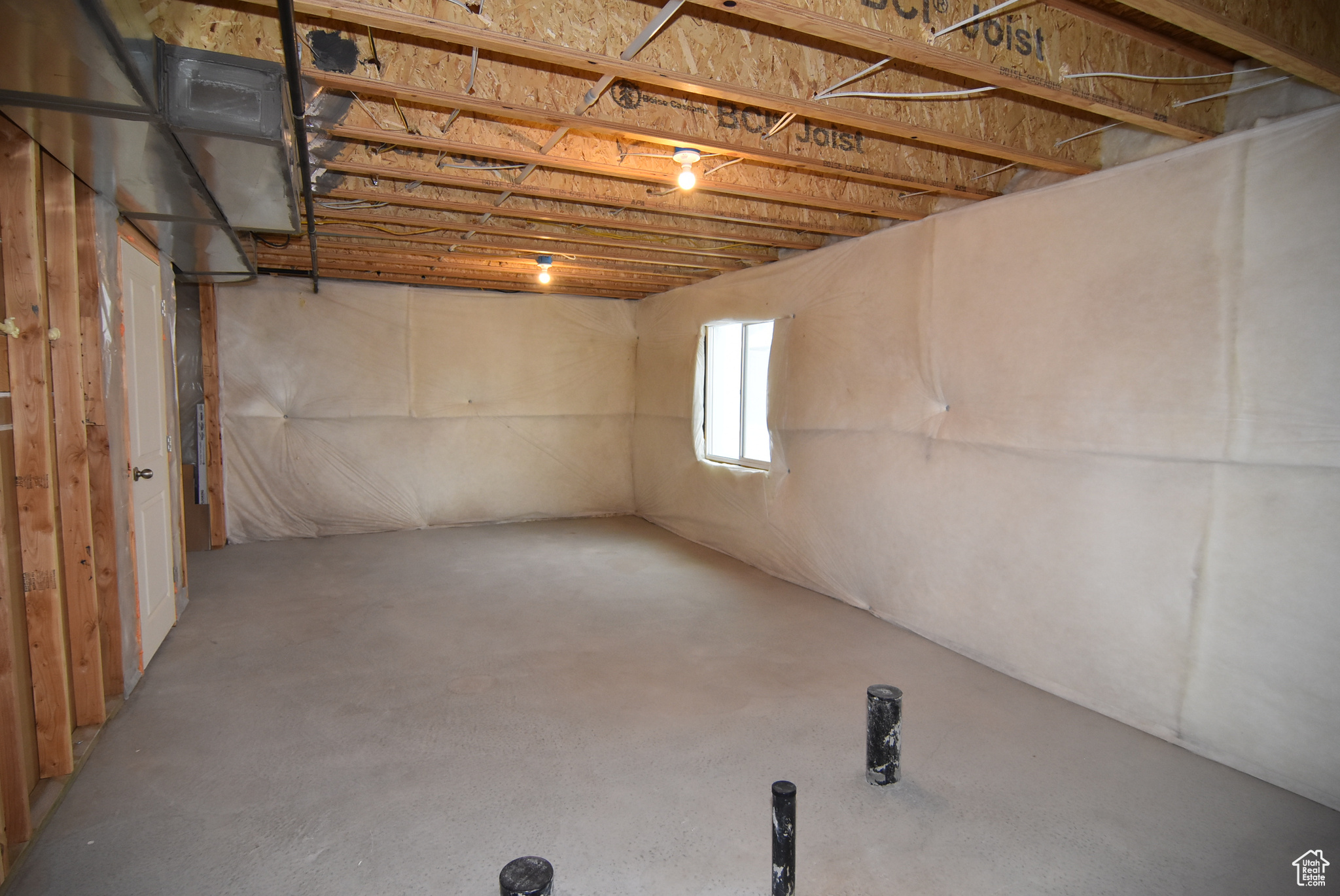 View of unfinished basement area with stub for future bathroom,