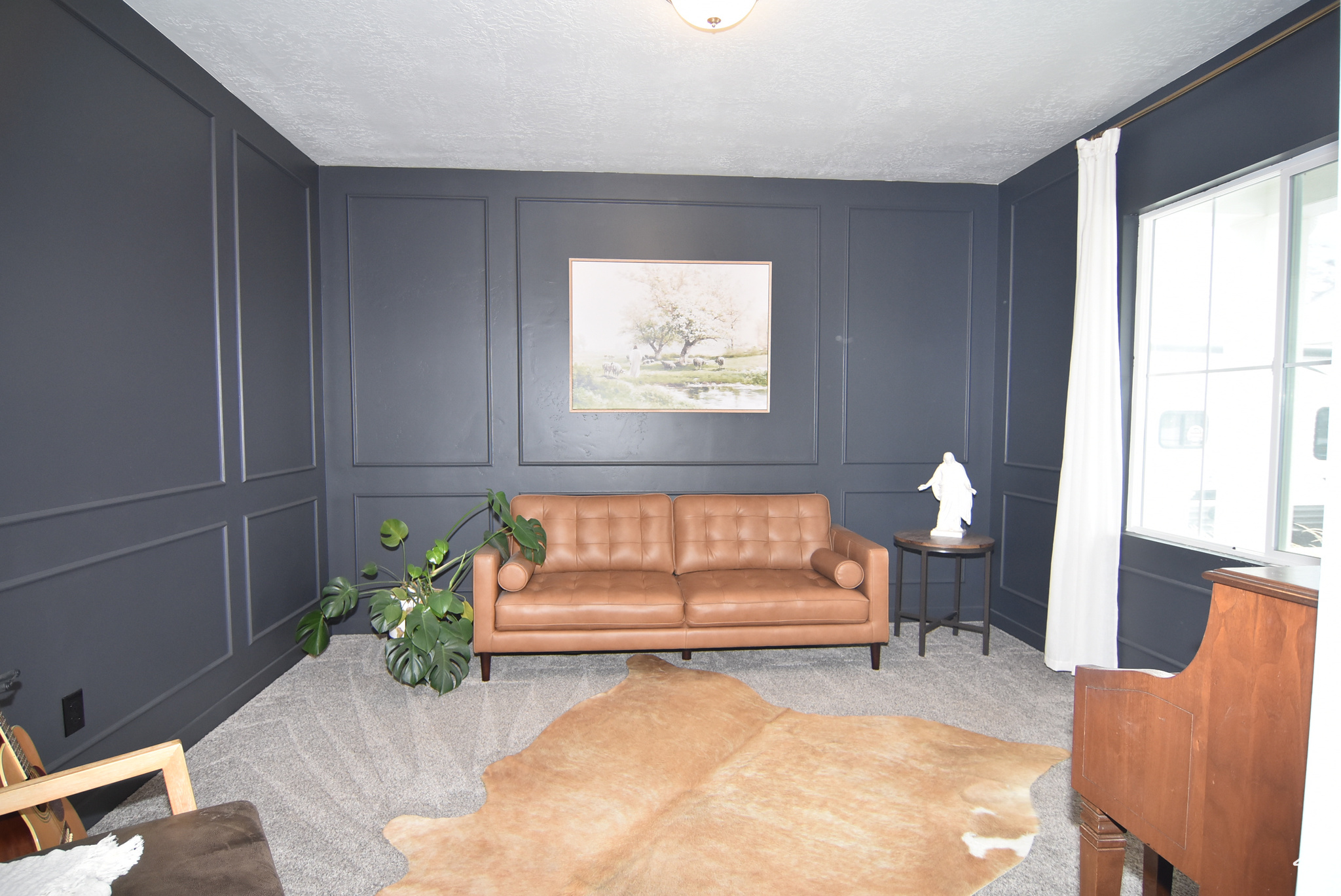 Carpeted living room featuring a textured ceiling