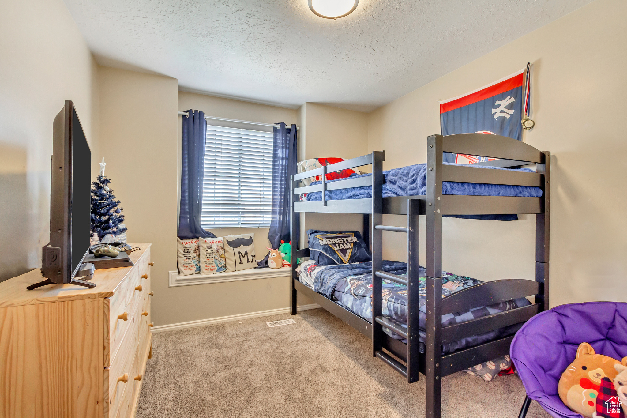 Bedroom with carpet flooring and a textured ceiling