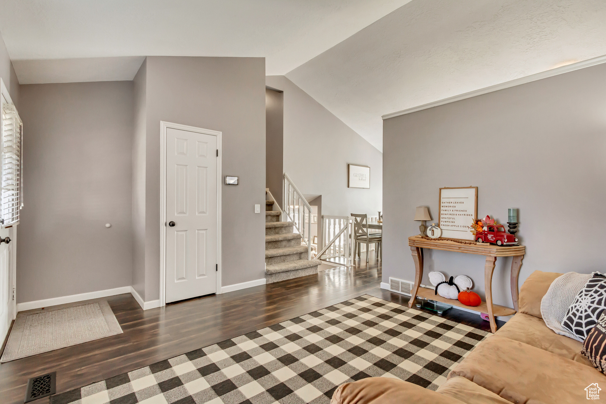 Entrance foyer featuring dark hardwood / wood-style flooring and vaulted ceiling