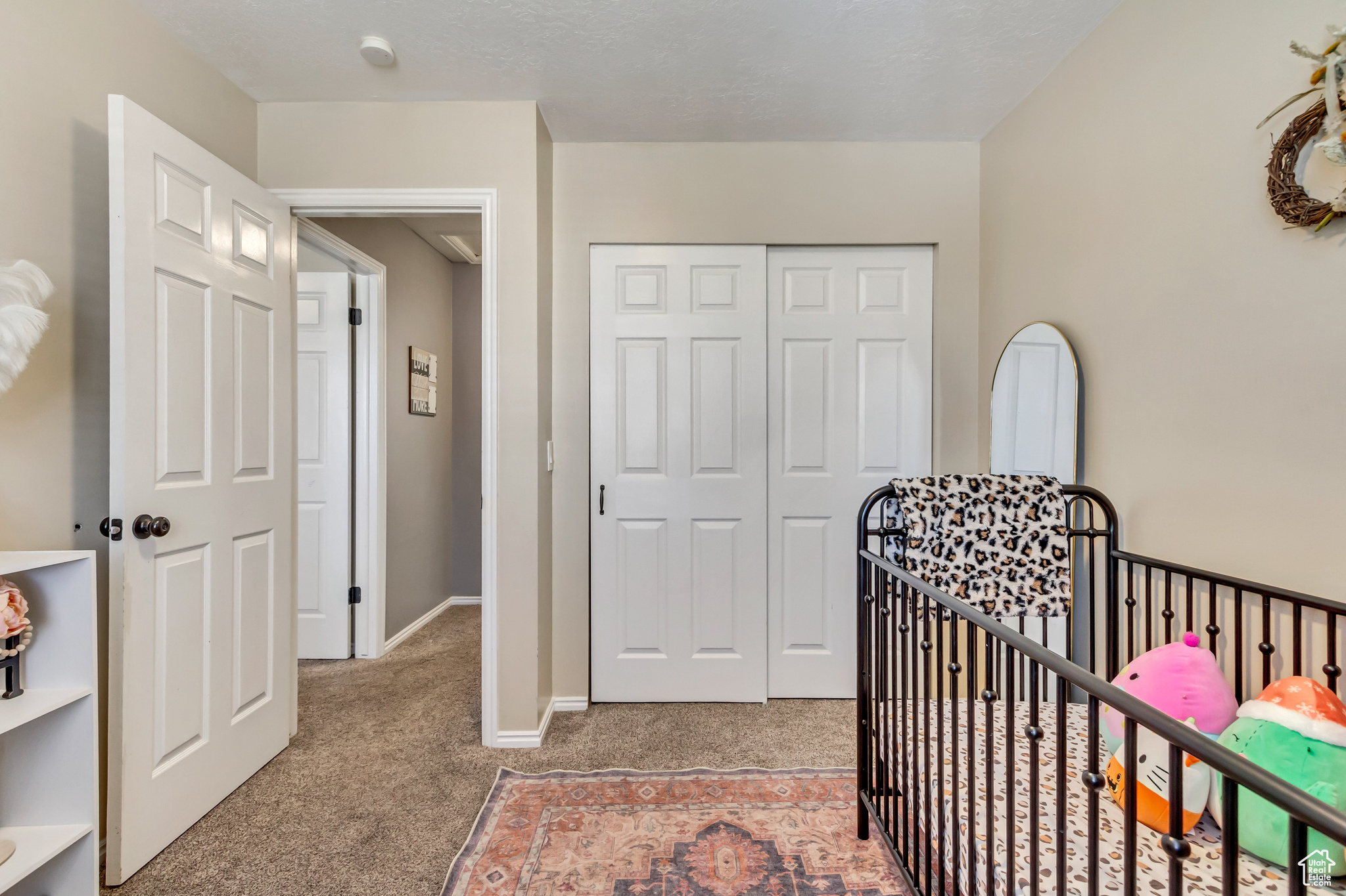 Carpeted bedroom featuring a closet