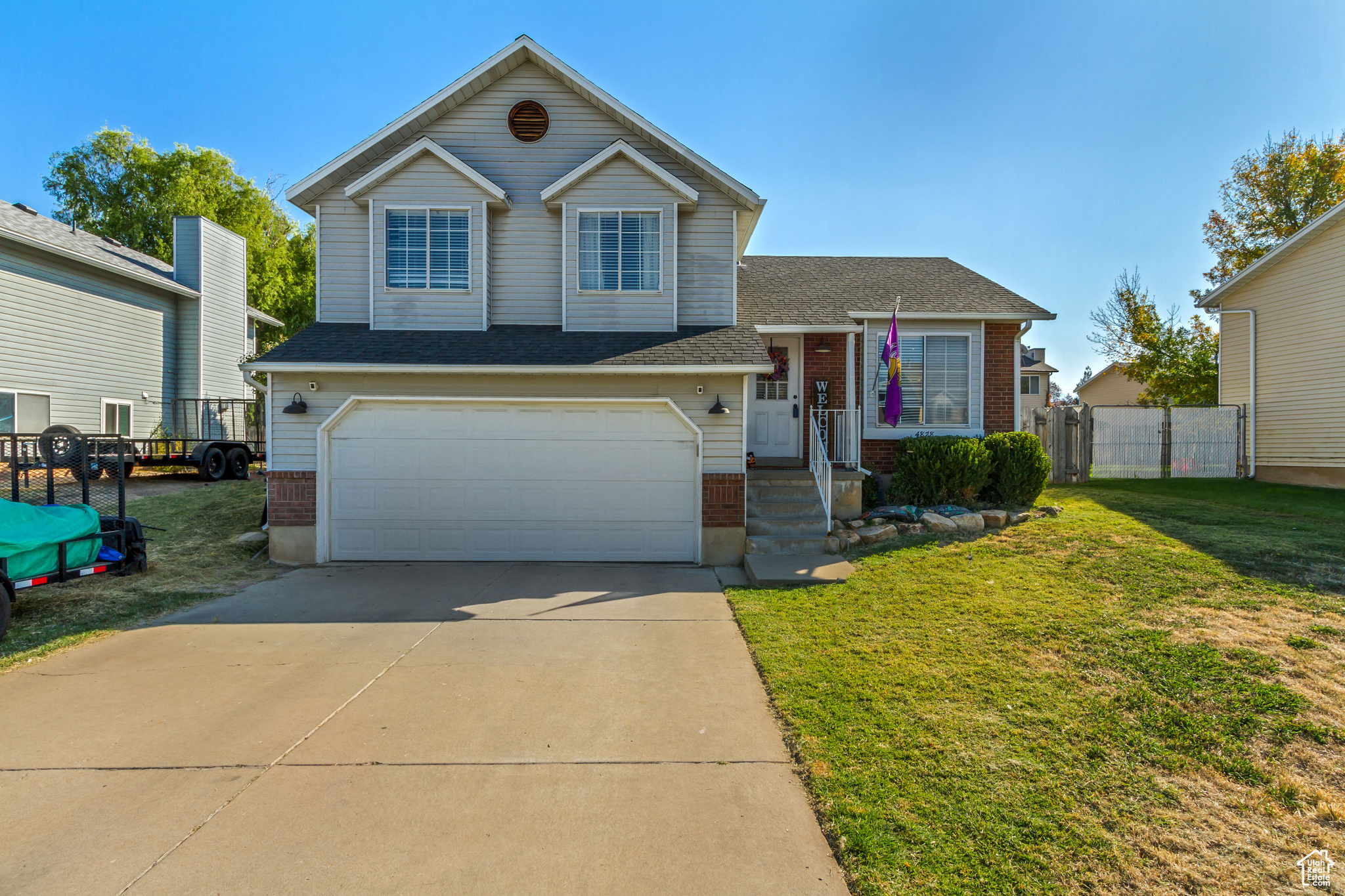 View of front of house featuring a front yard and a garage