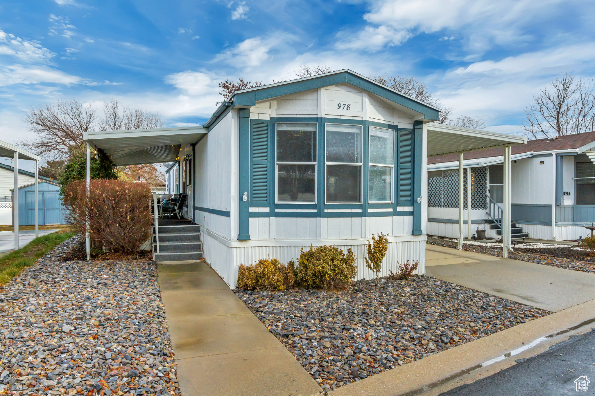 View of front facade featuring covered patio and carport.