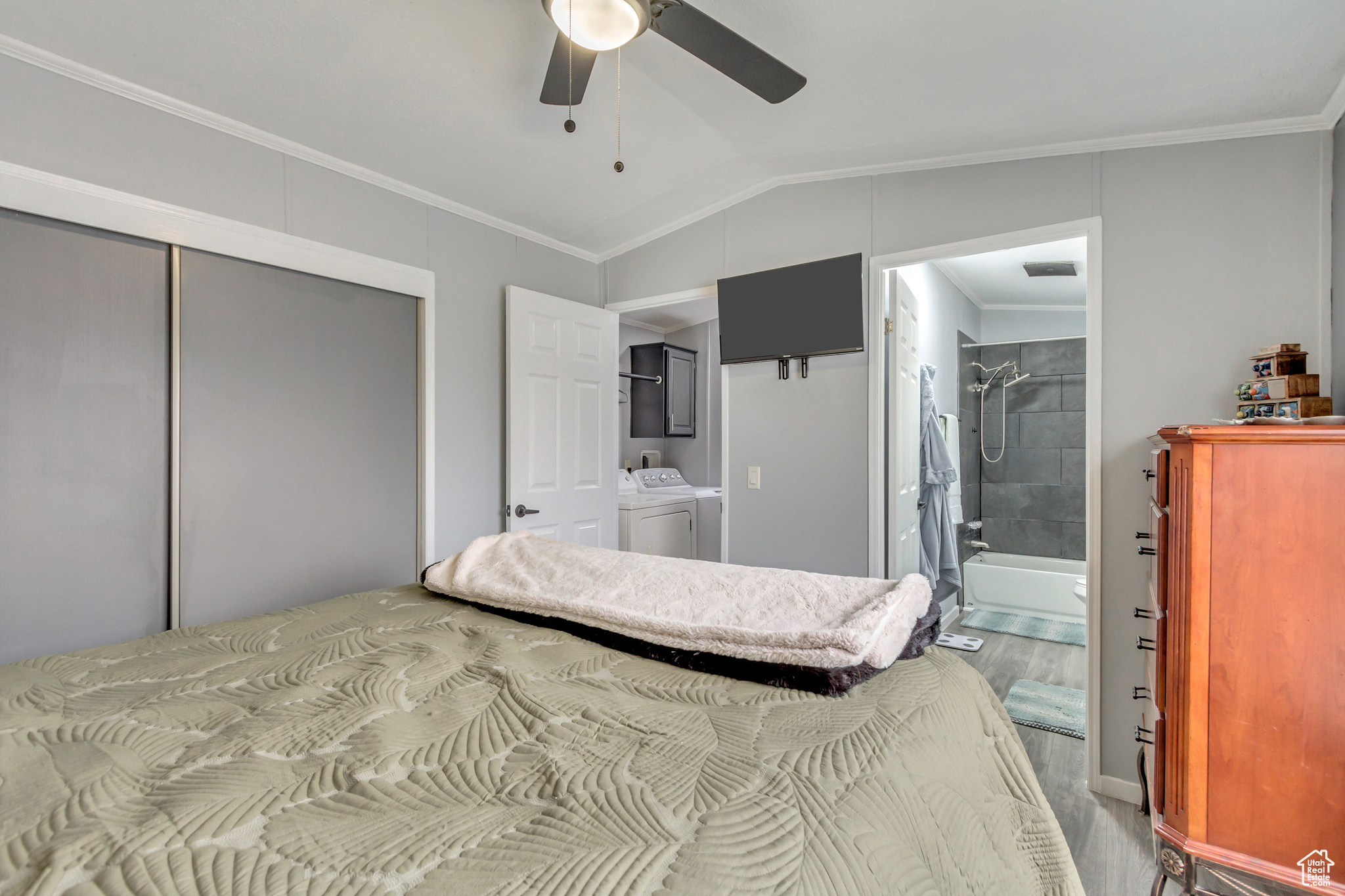 Master bedroom featuring ceiling fan, large closet, window, and en-suite bathroom.