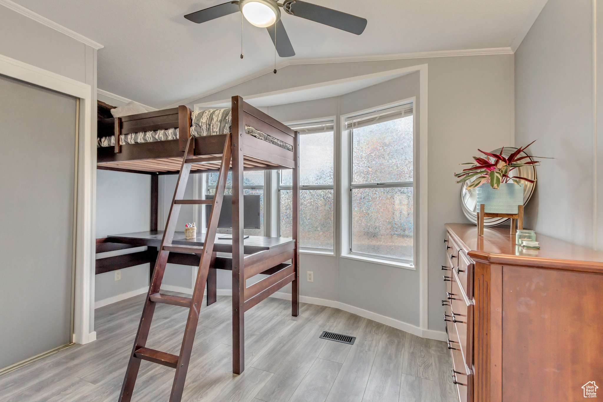 Second Bedroom featuring ceiling fan, closet, and lots of natural light.