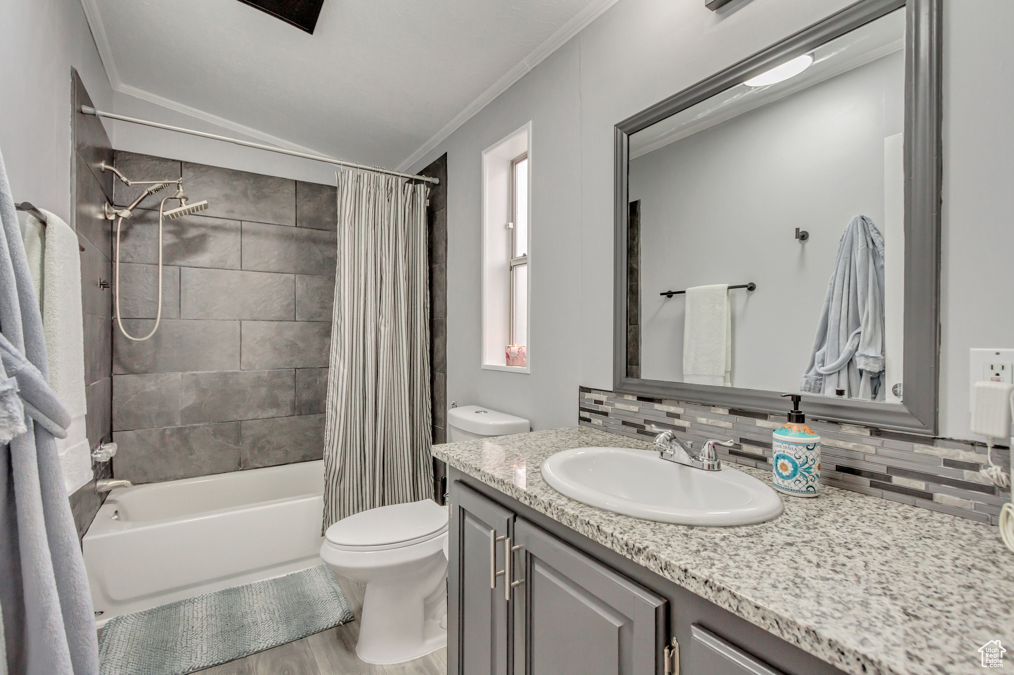 Master bathroom with granite countertops. New flooring, toilet, tub, tile, and hardware.