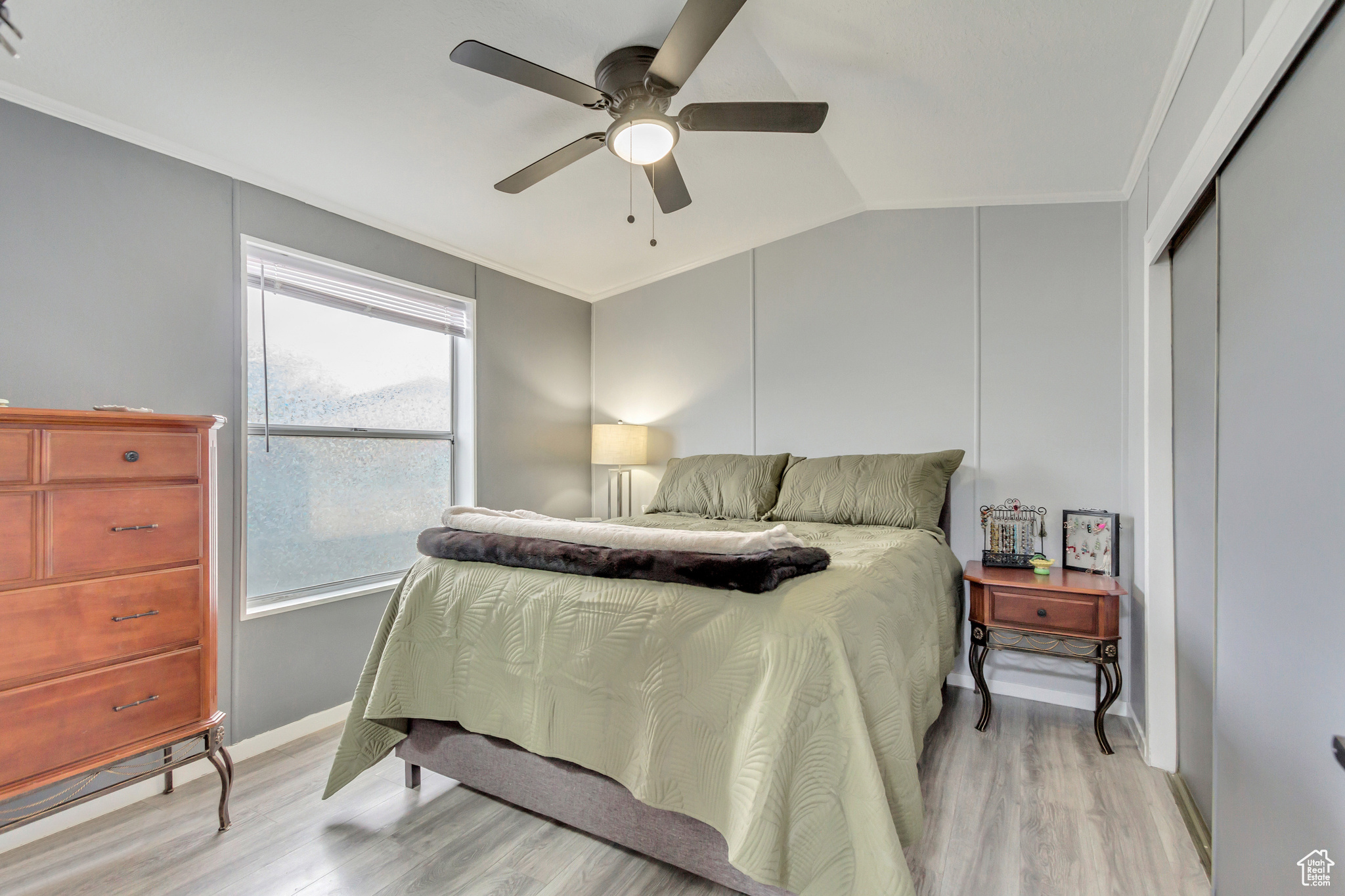 Master bedroom featuring ceiling fan, large closet, window, and en-suite bathroom.