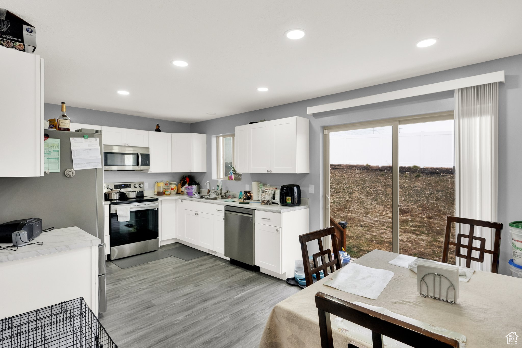 Kitchen featuring sink, white cabinets, a healthy amount of sunlight, and appliances with stainless steel finishes