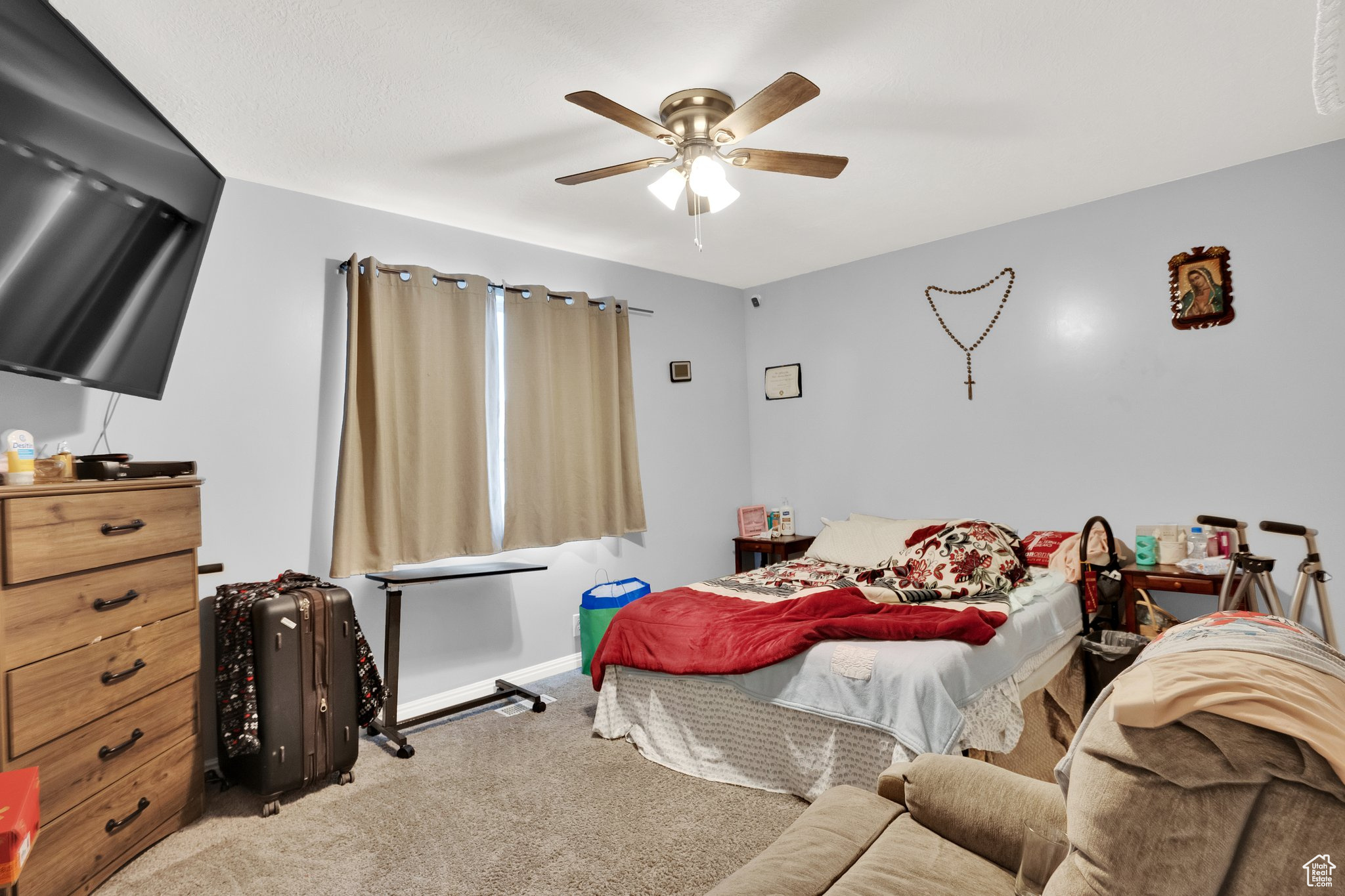 Bedroom featuring ceiling fan and carpet floors