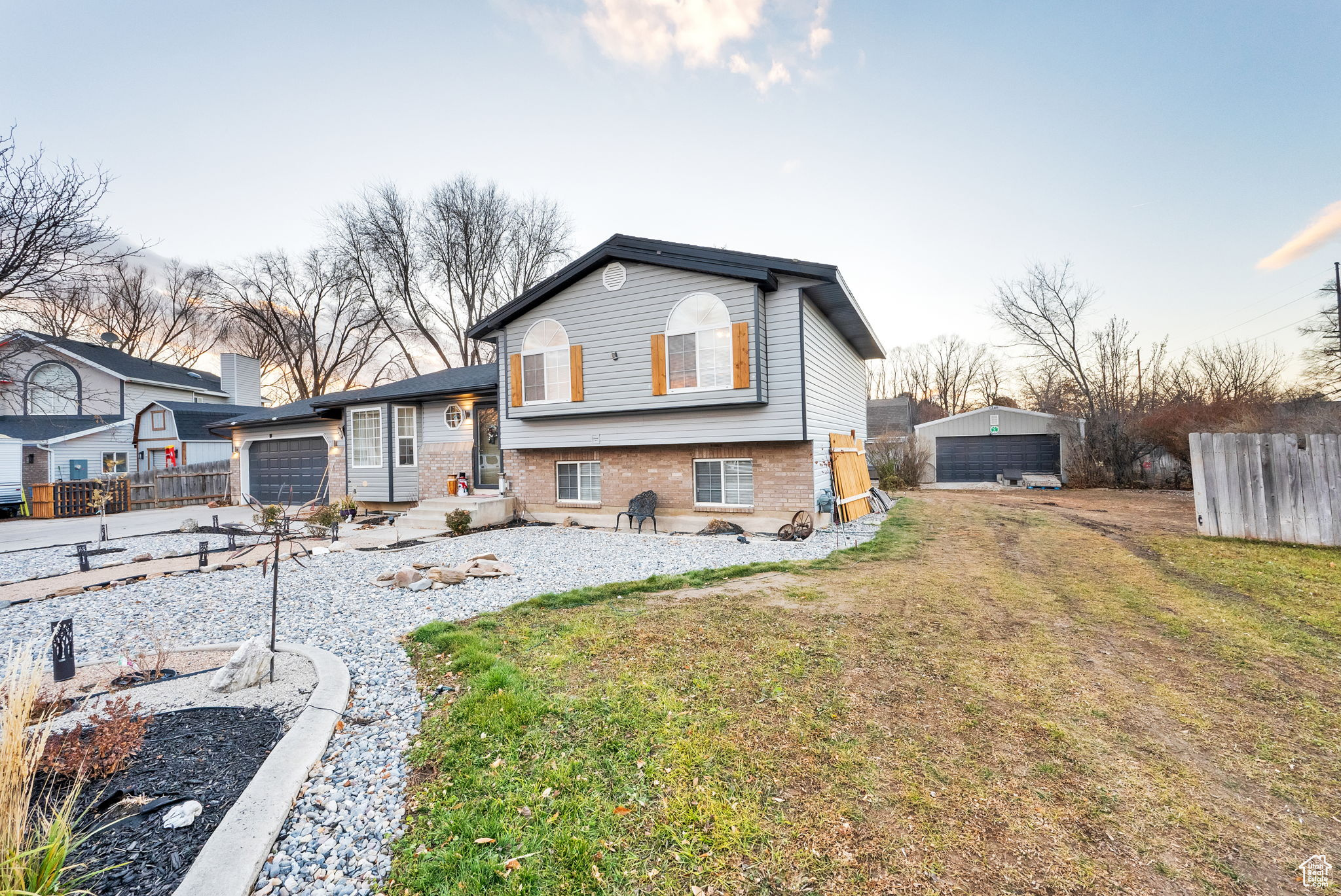 Rear view of property featuring a lawn and a garage