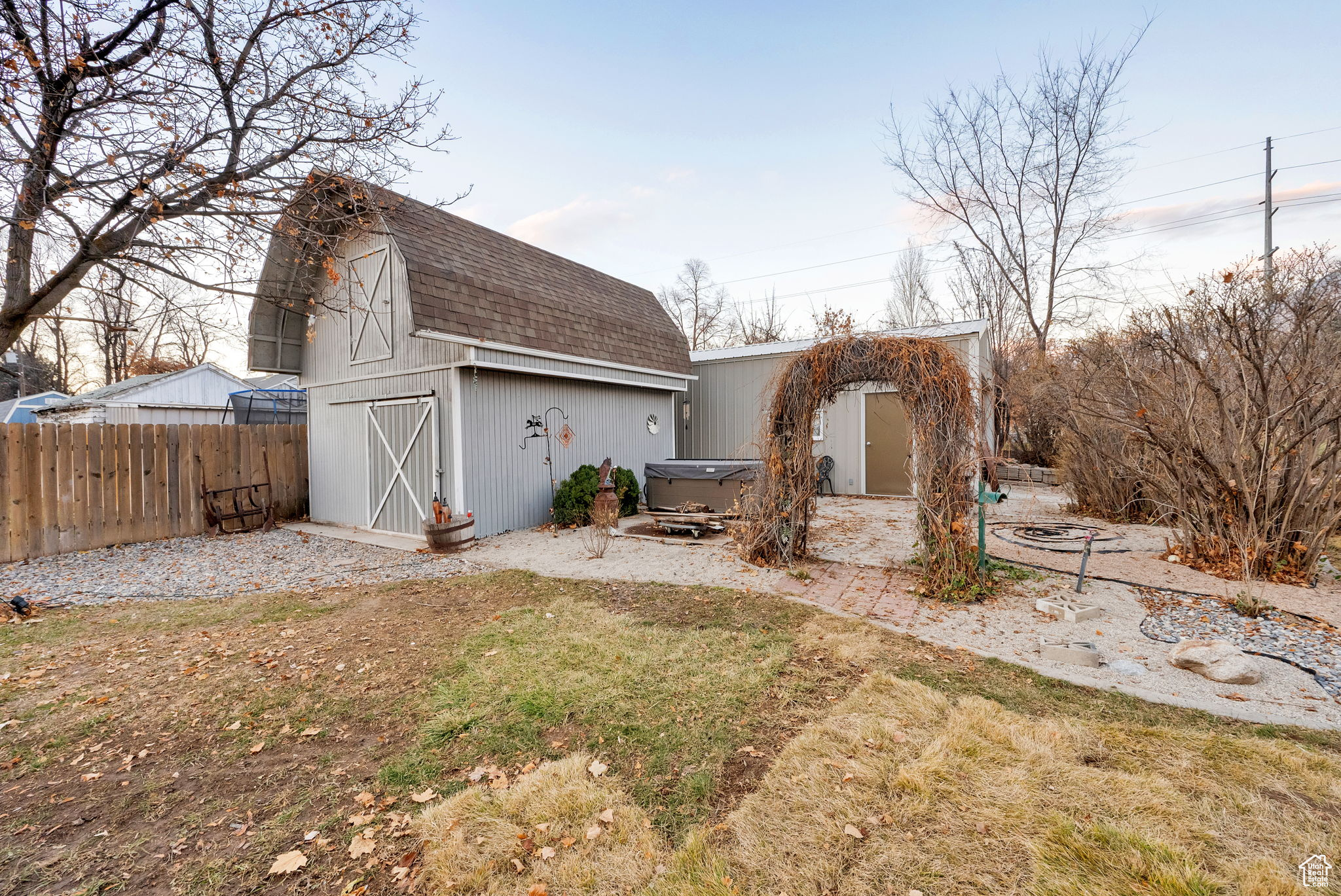 Exterior space featuring an outdoor structure and a hot tub