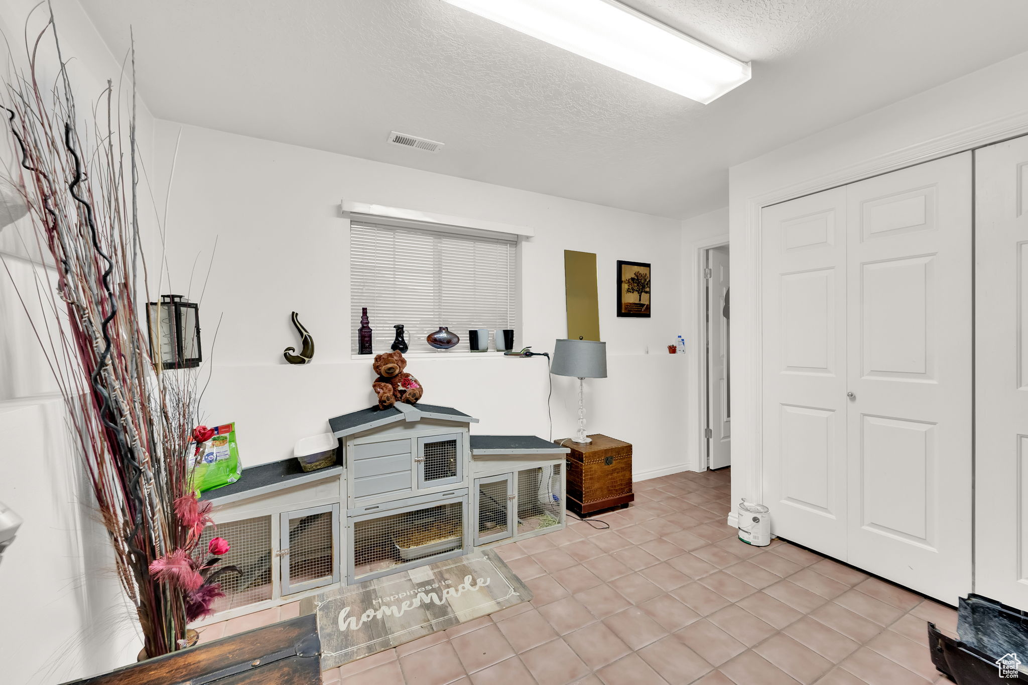 Living room with light tile patterned floors and a textured ceiling