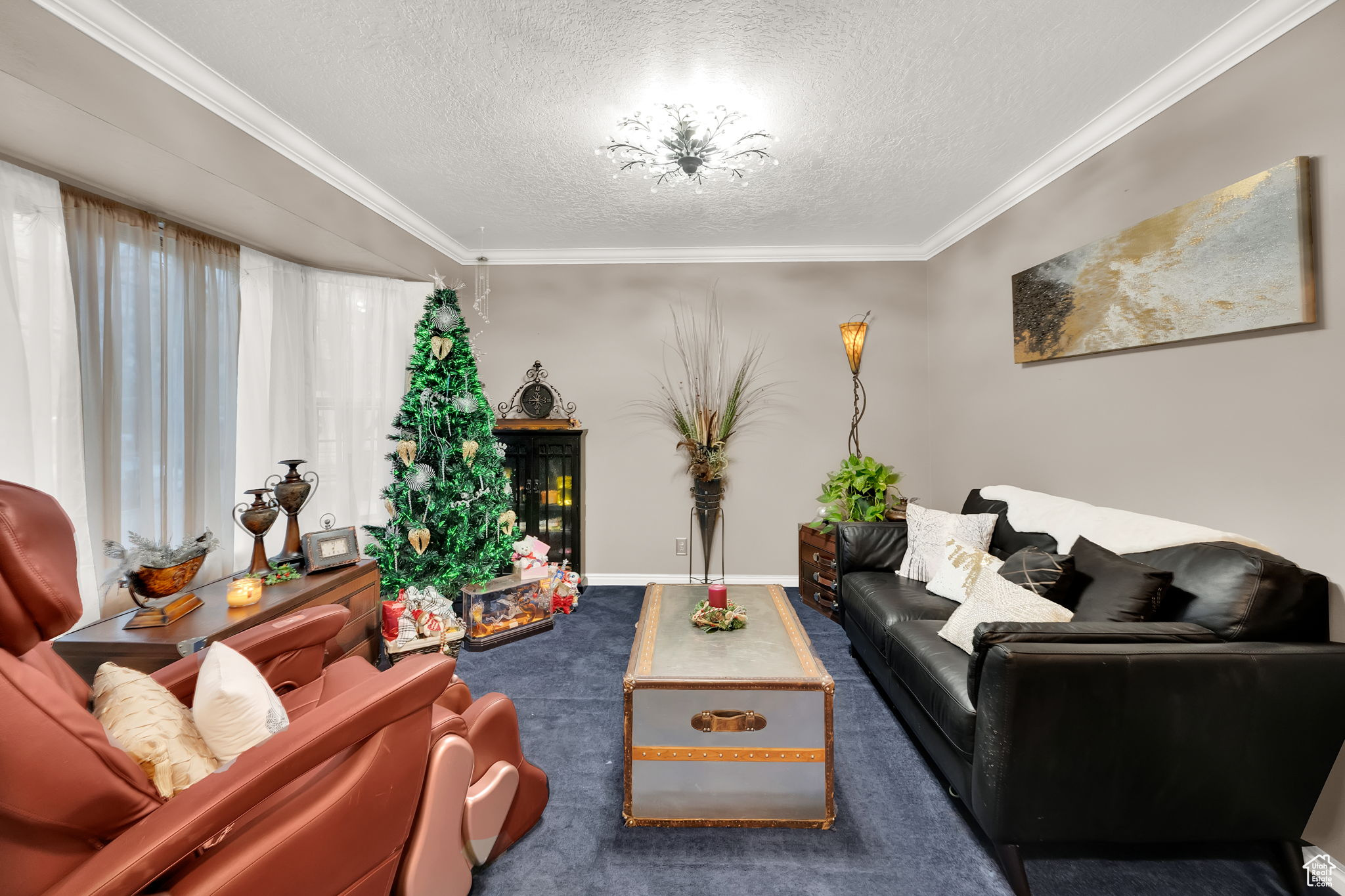 Living room with ornamental molding and a textured ceiling