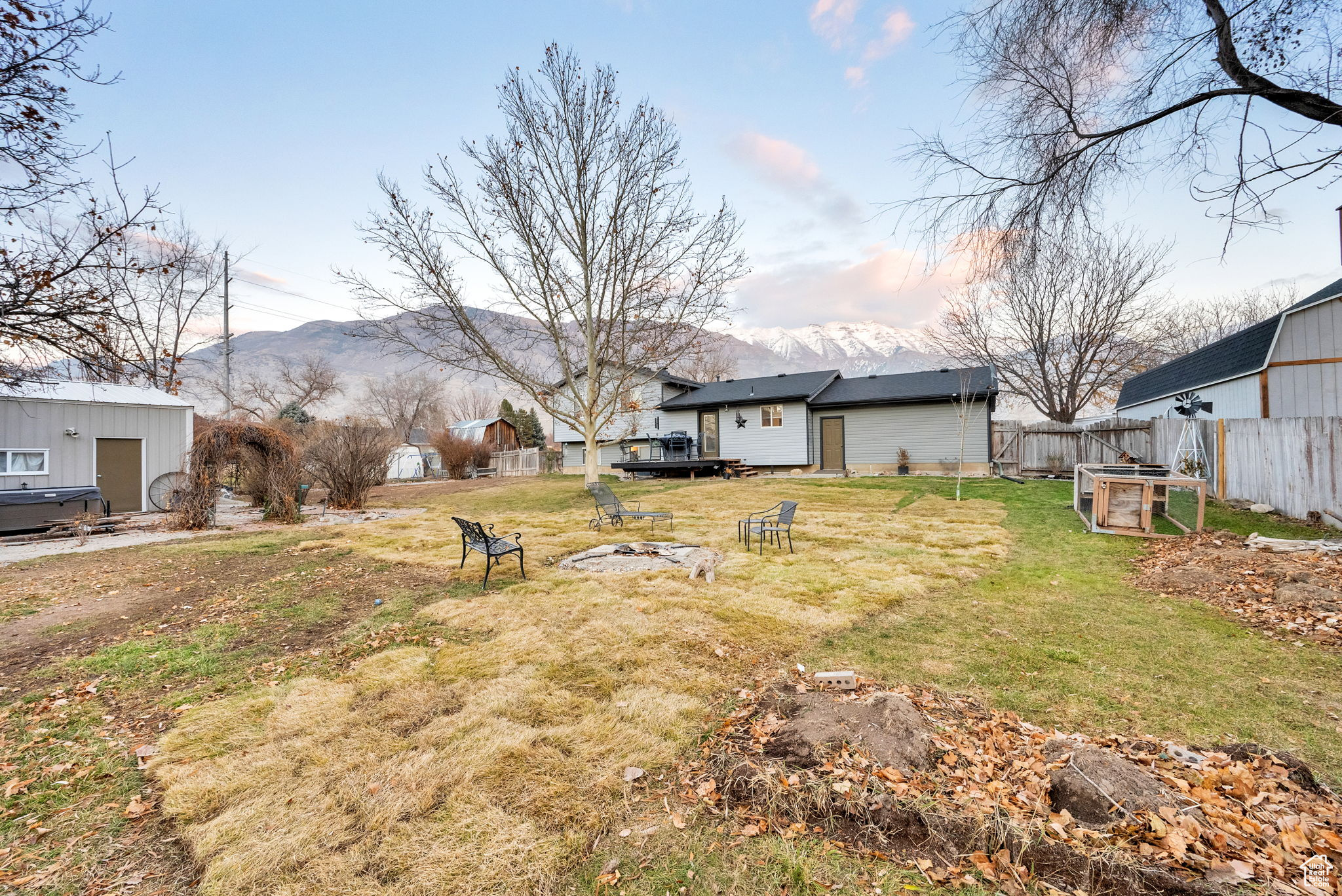 View of yard with a deck with mountain view and an outdoor structure