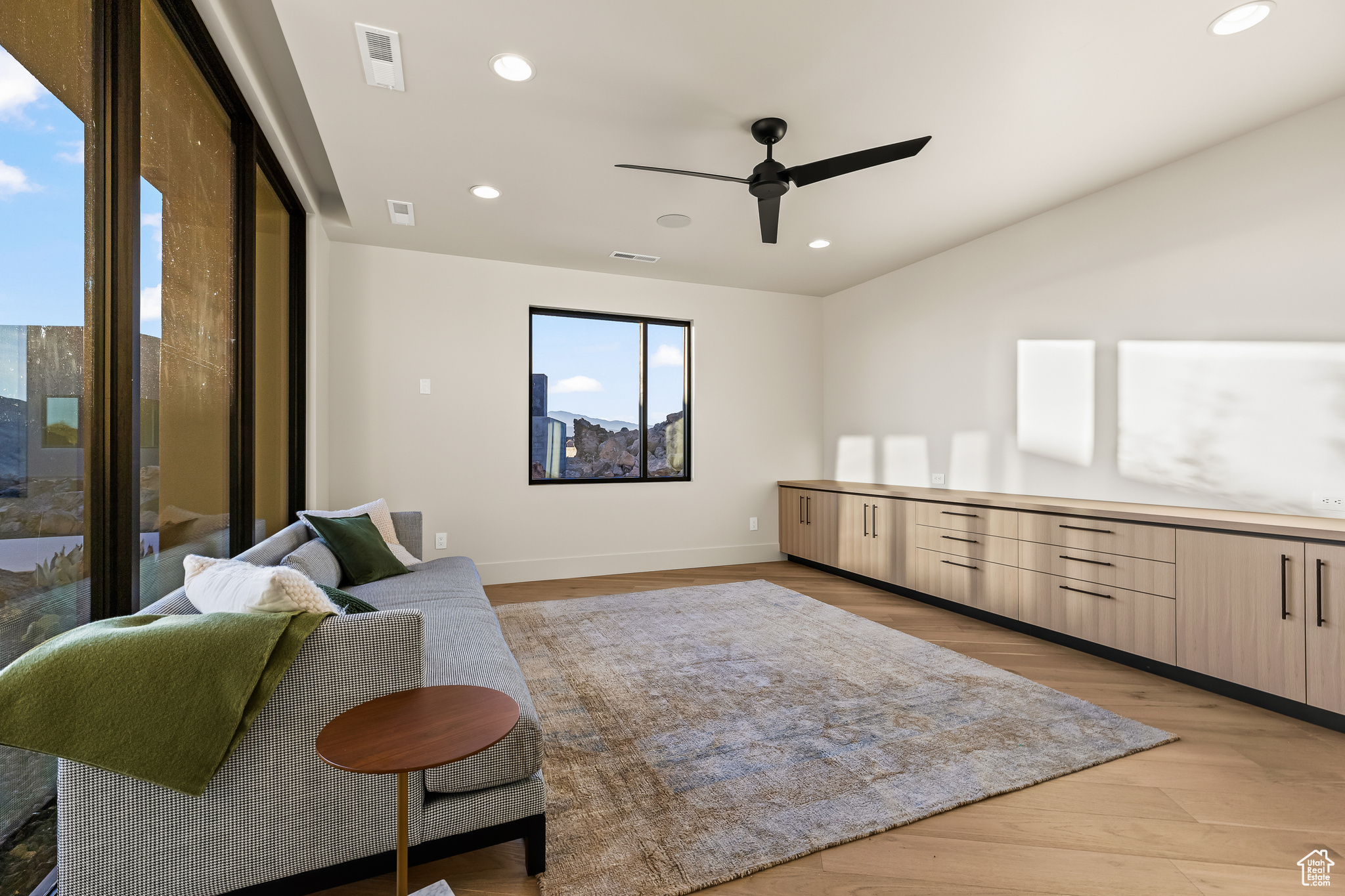 Sitting room featuring ceiling fan and light hardwood / wood-style flooring