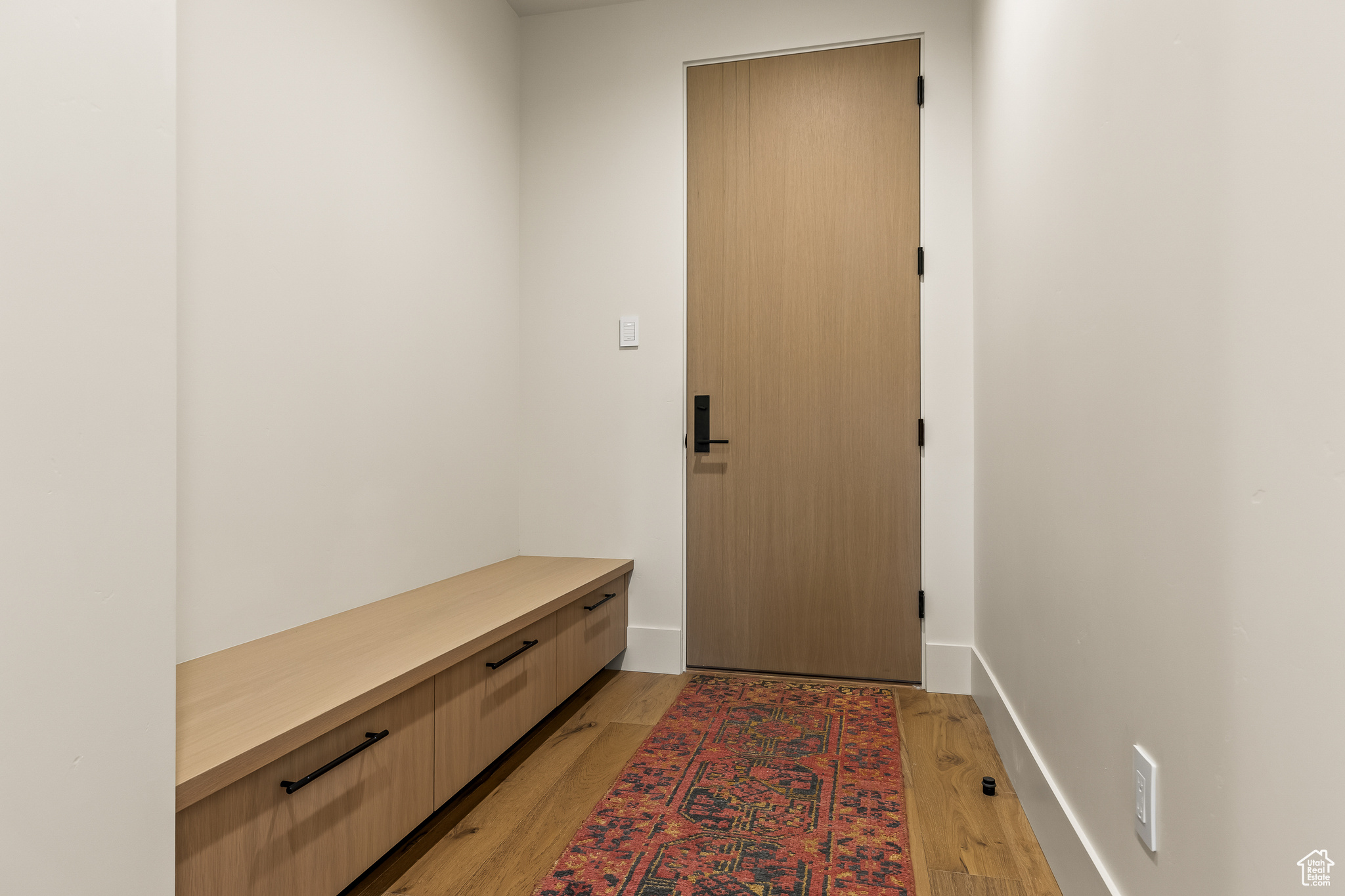 Mudroom with light hardwood / wood-style floors