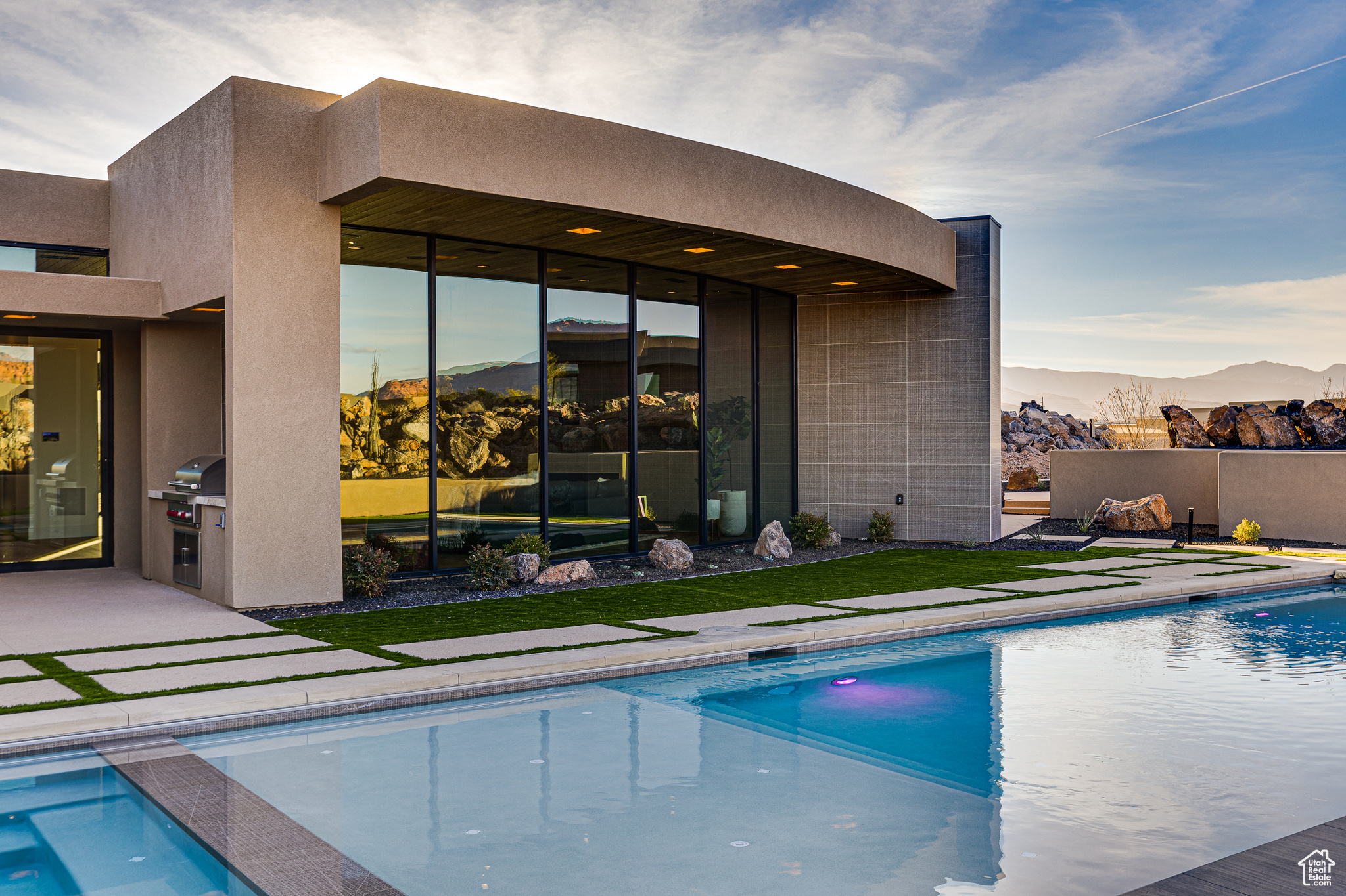 View of pool with grilling area, a mountain view, area for grilling, and a patio