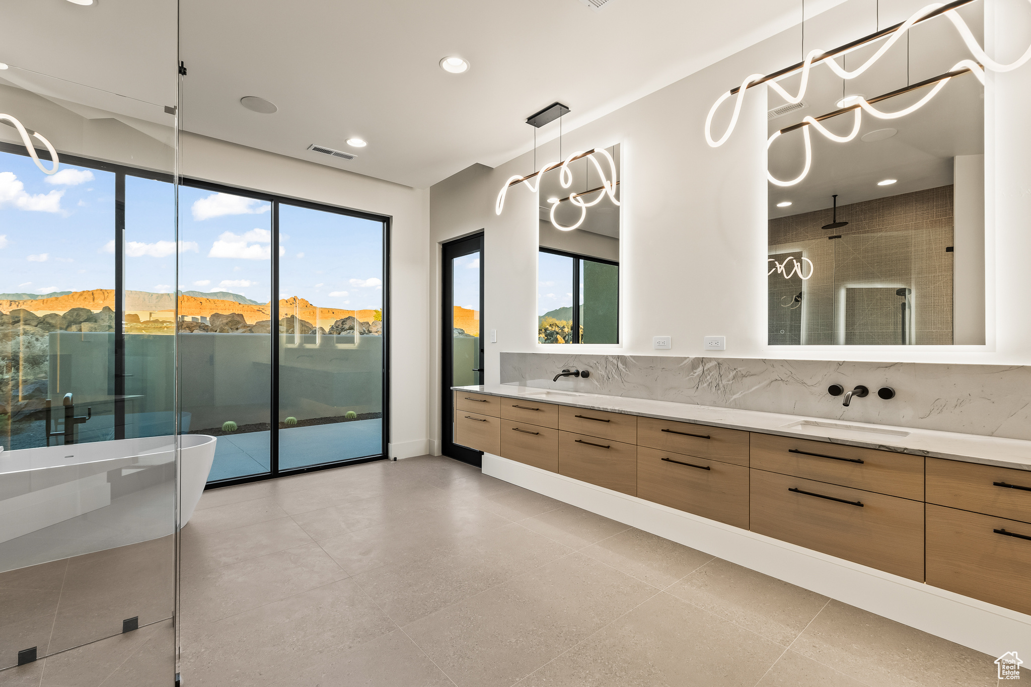 Bathroom featuring tasteful backsplash, vanity, separate shower and tub, a mountain view, and tile patterned flooring