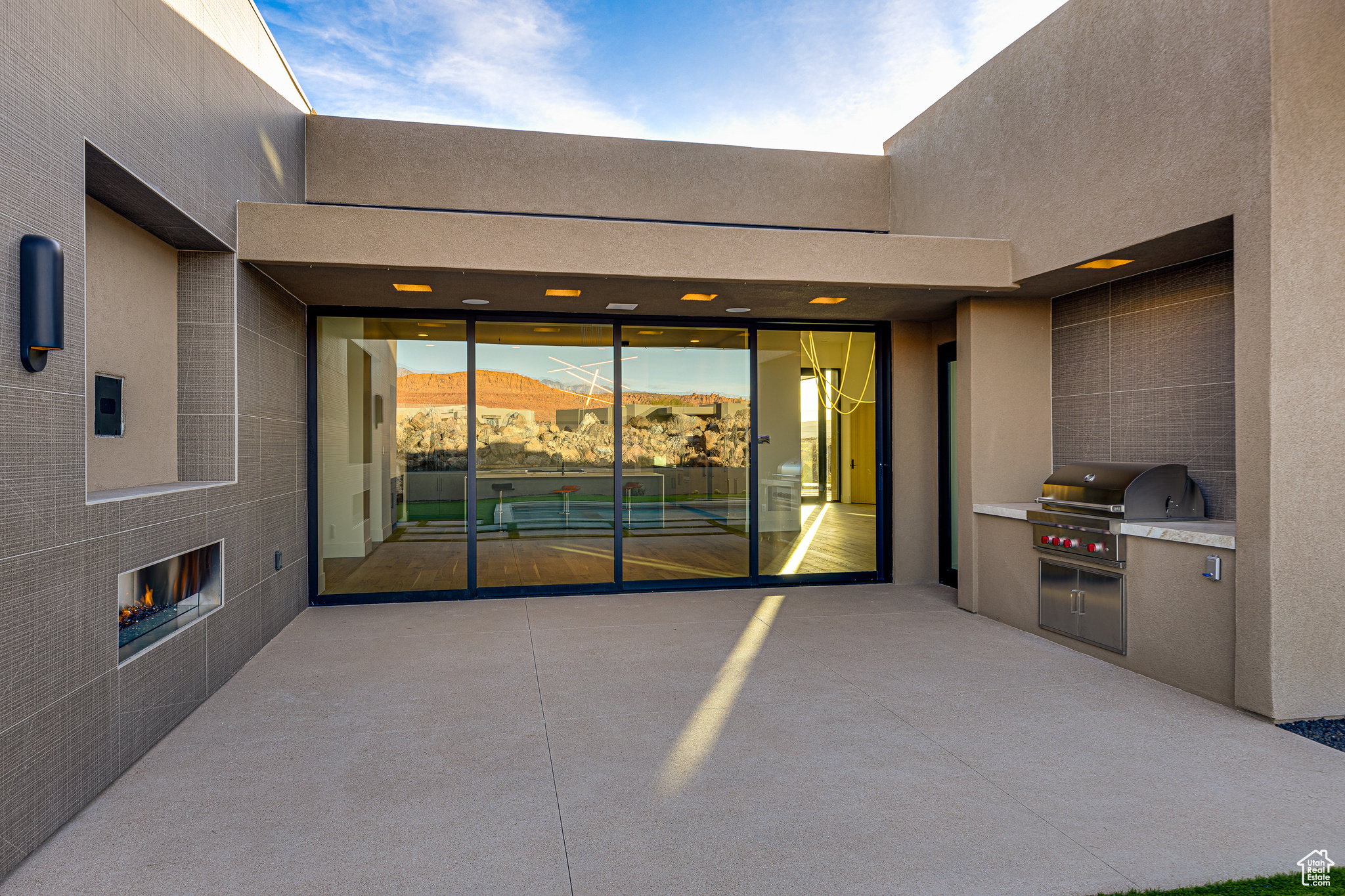 View of patio / terrace with a mountain view, a grill, and a tiled fireplace