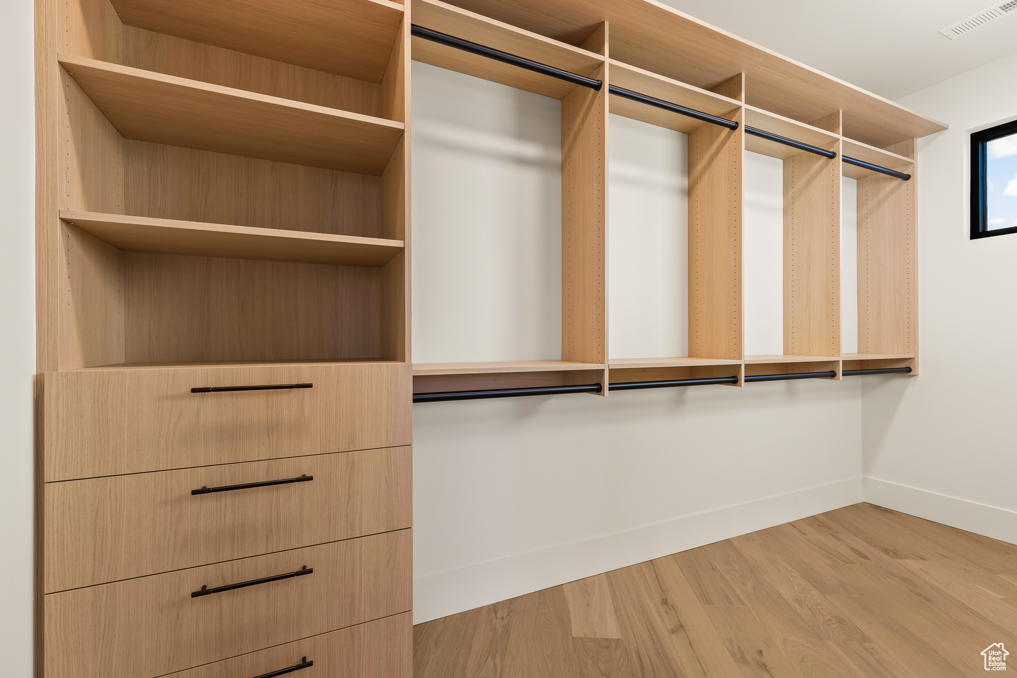 Walk in closet featuring hardwood / wood-style floors