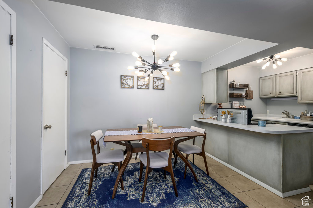 Tiled dining room with an inviting chandelier