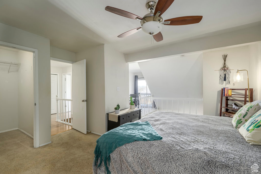 Bedroom featuring light colored carpet, a closet, and ceiling fan