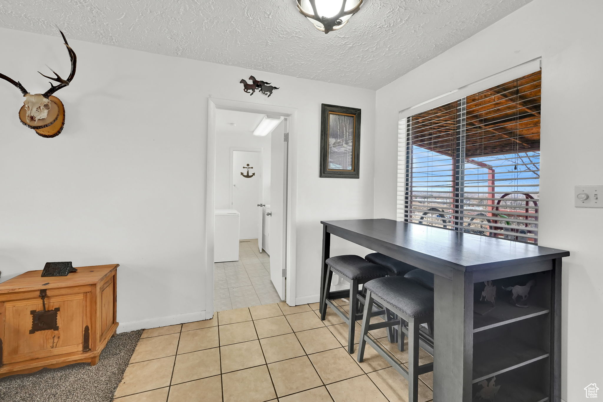 Tiled dining space featuring a textured ceiling