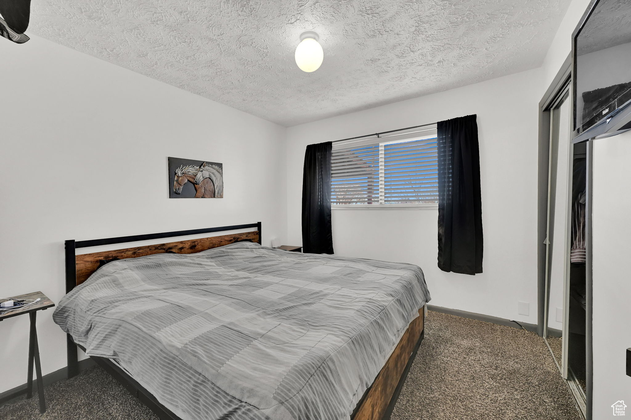 Bedroom with carpet flooring and a textured ceiling