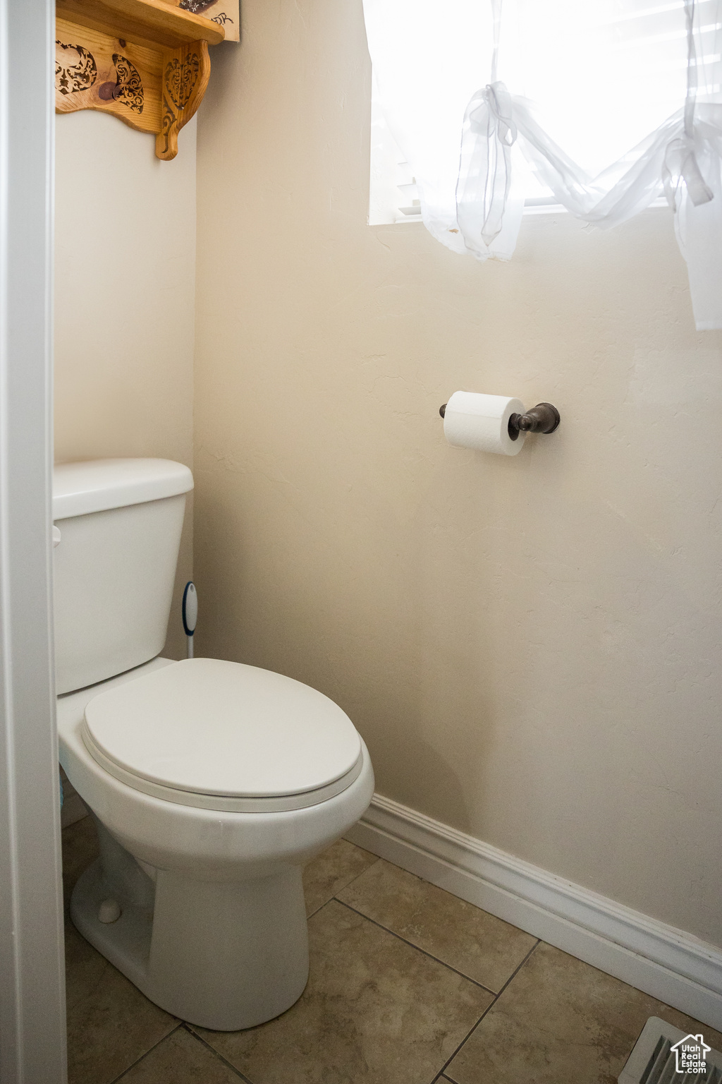 Bathroom with tile patterned floors and toilet