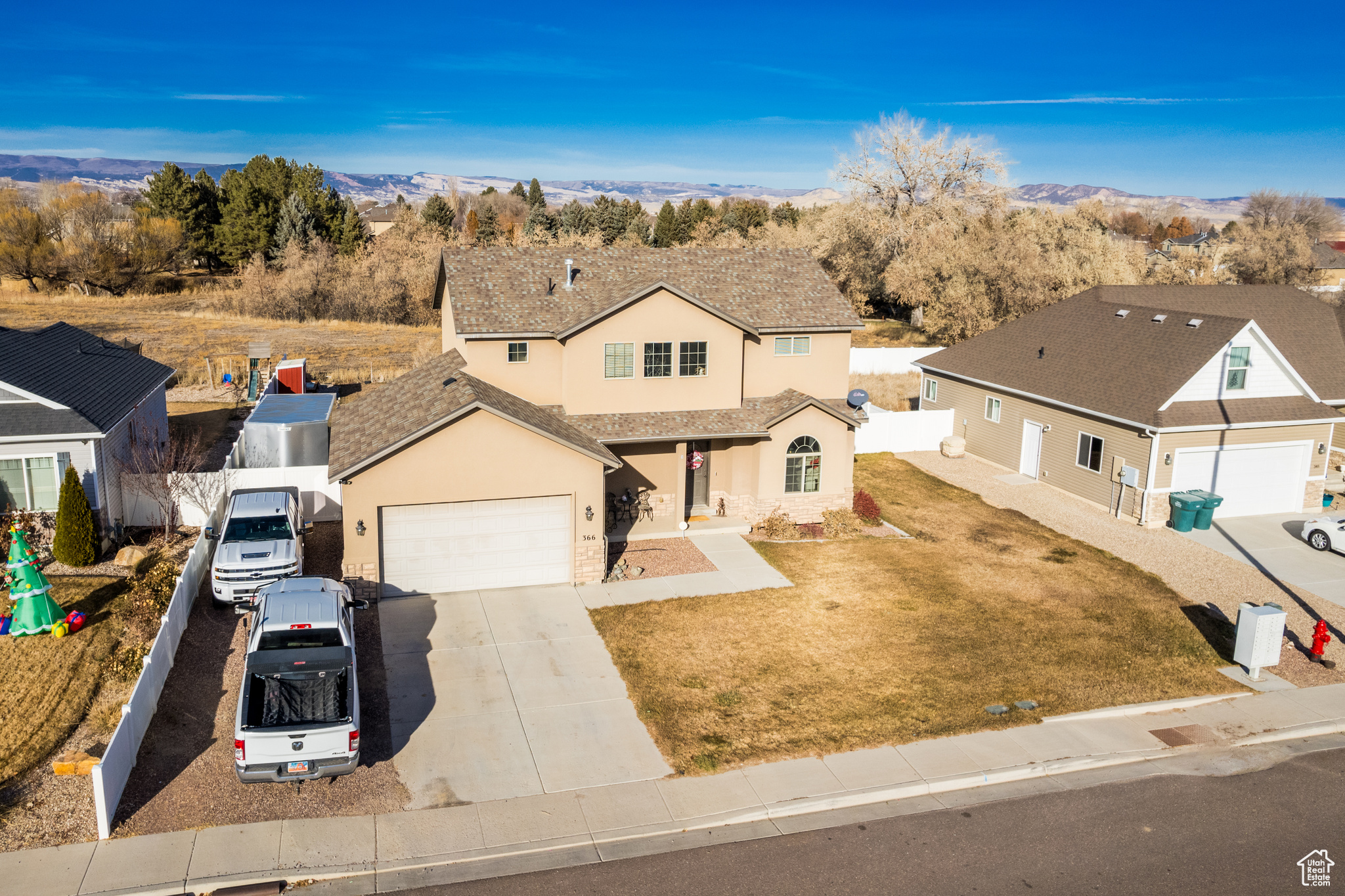 View of front of property with a mountain view and a garage