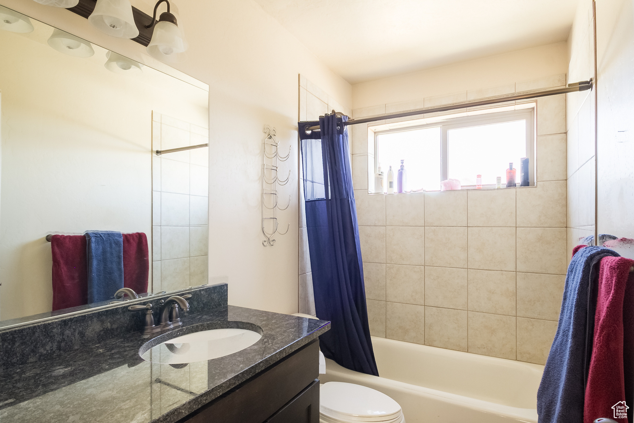 Full bathroom with vanity, toilet, and shower / tub combo