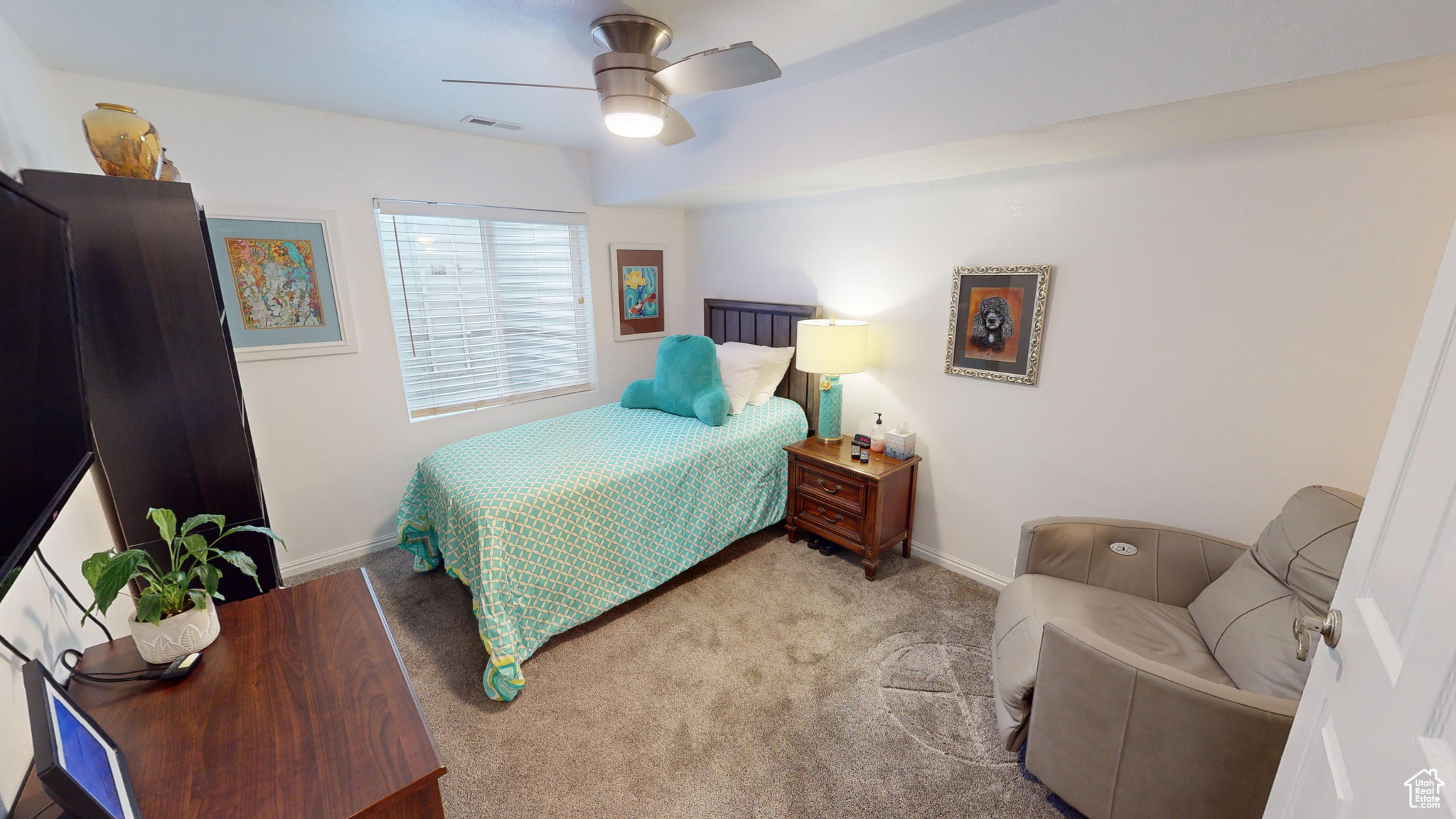 Bedroom featuring light colored carpet and ceiling fan