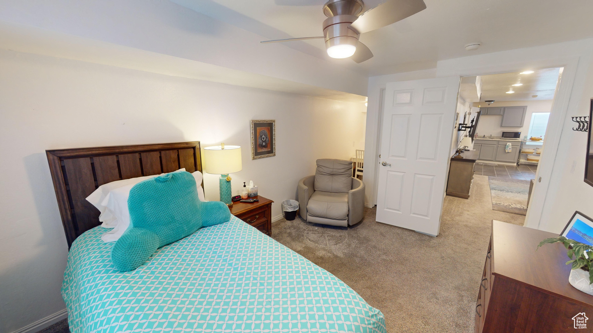 Carpeted bedroom featuring ceiling fan