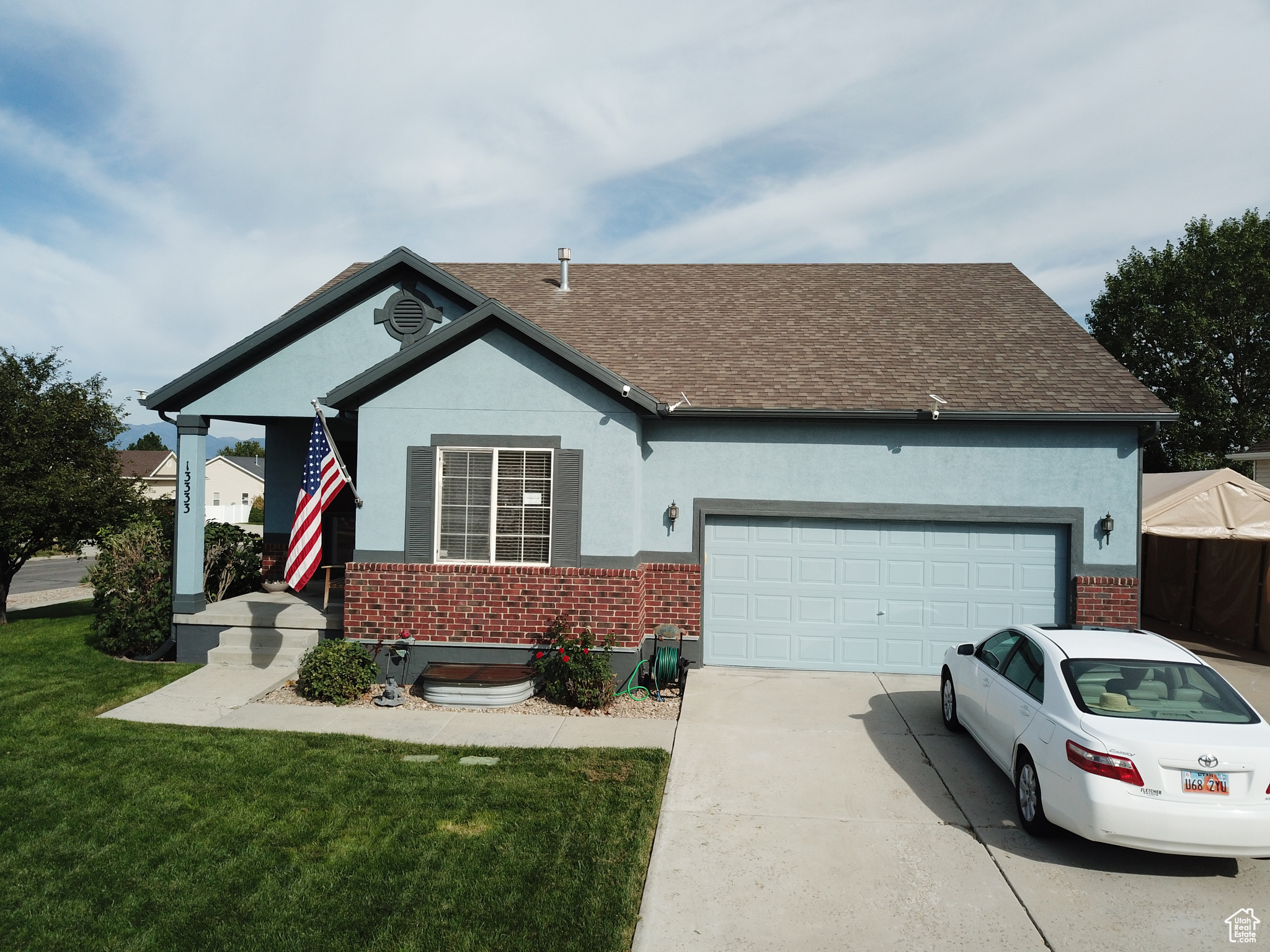 View of front of house with a garage and a front yard