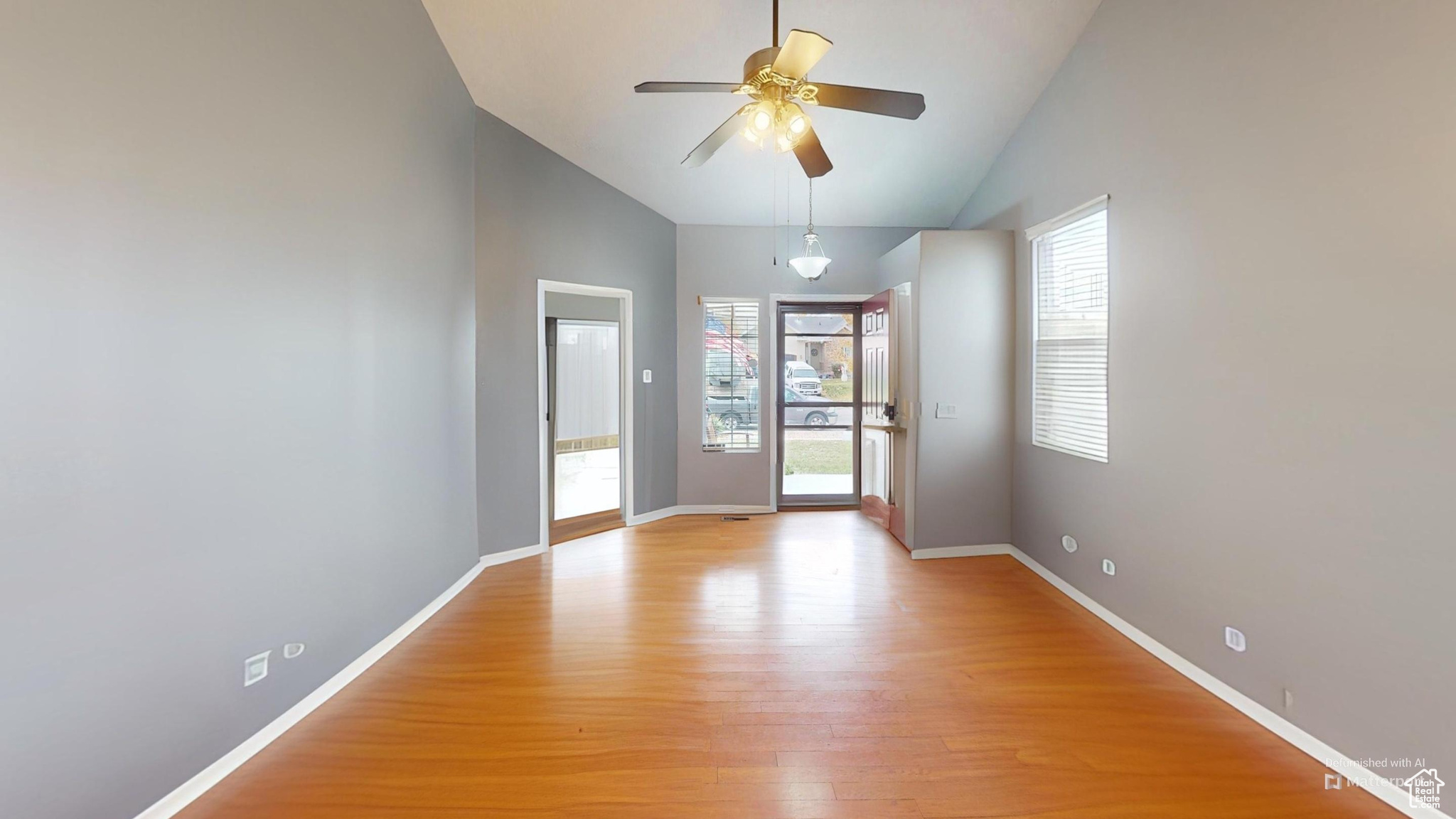 Virtually Un-staged room featuring ceiling fan, light hardwood / wood-style floors, and lofted ceiling