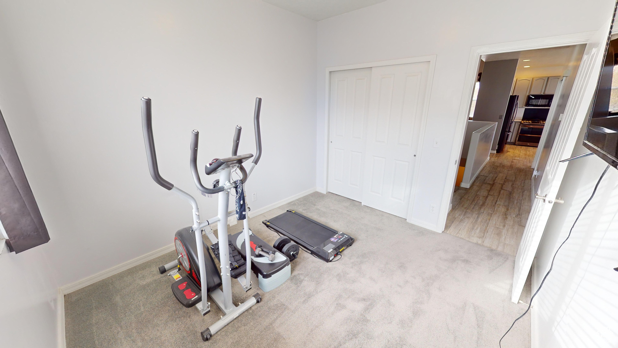 Workout room featuring light colored carpet