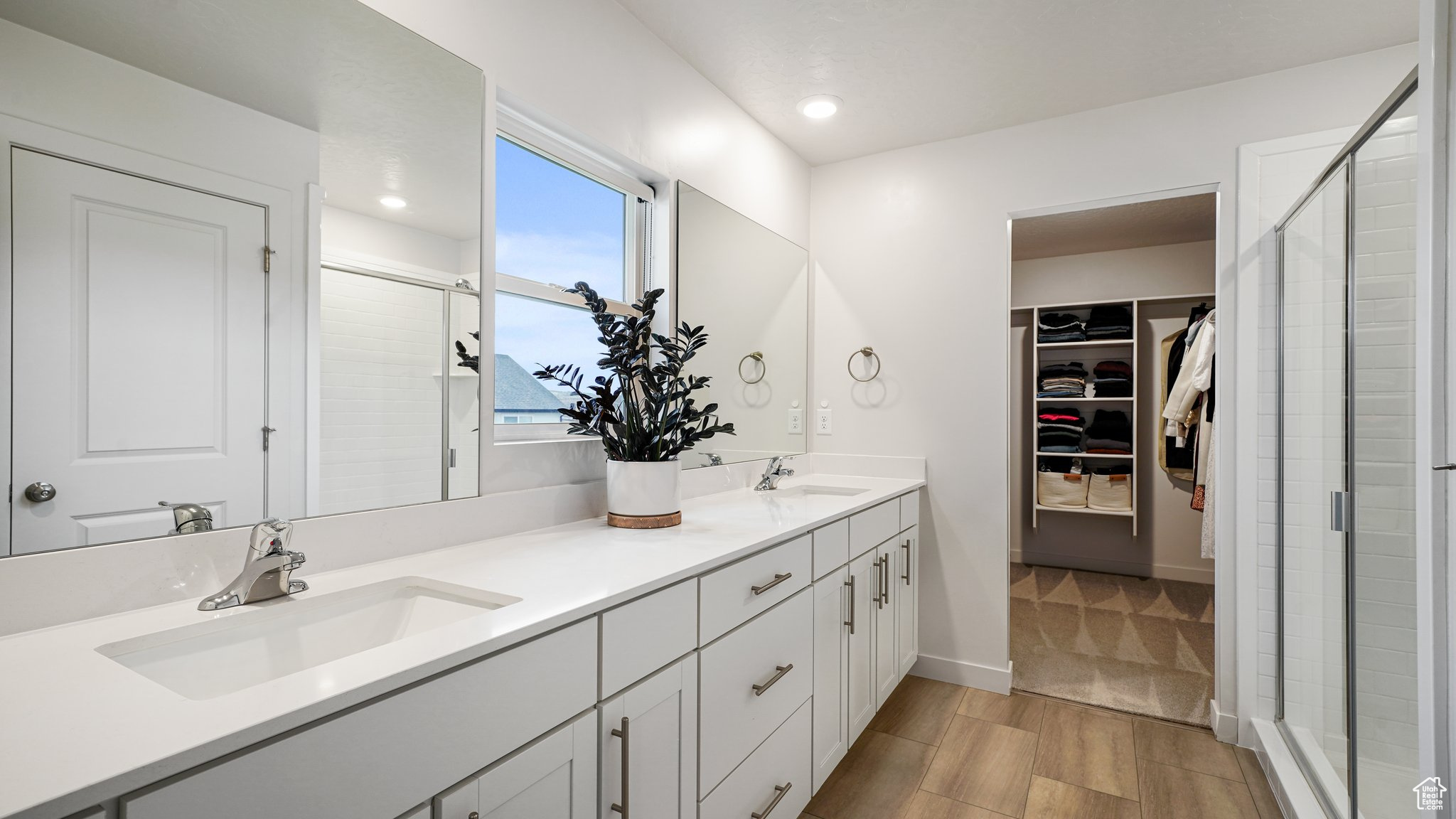 Bathroom with dual sink vanity and walk-in shower