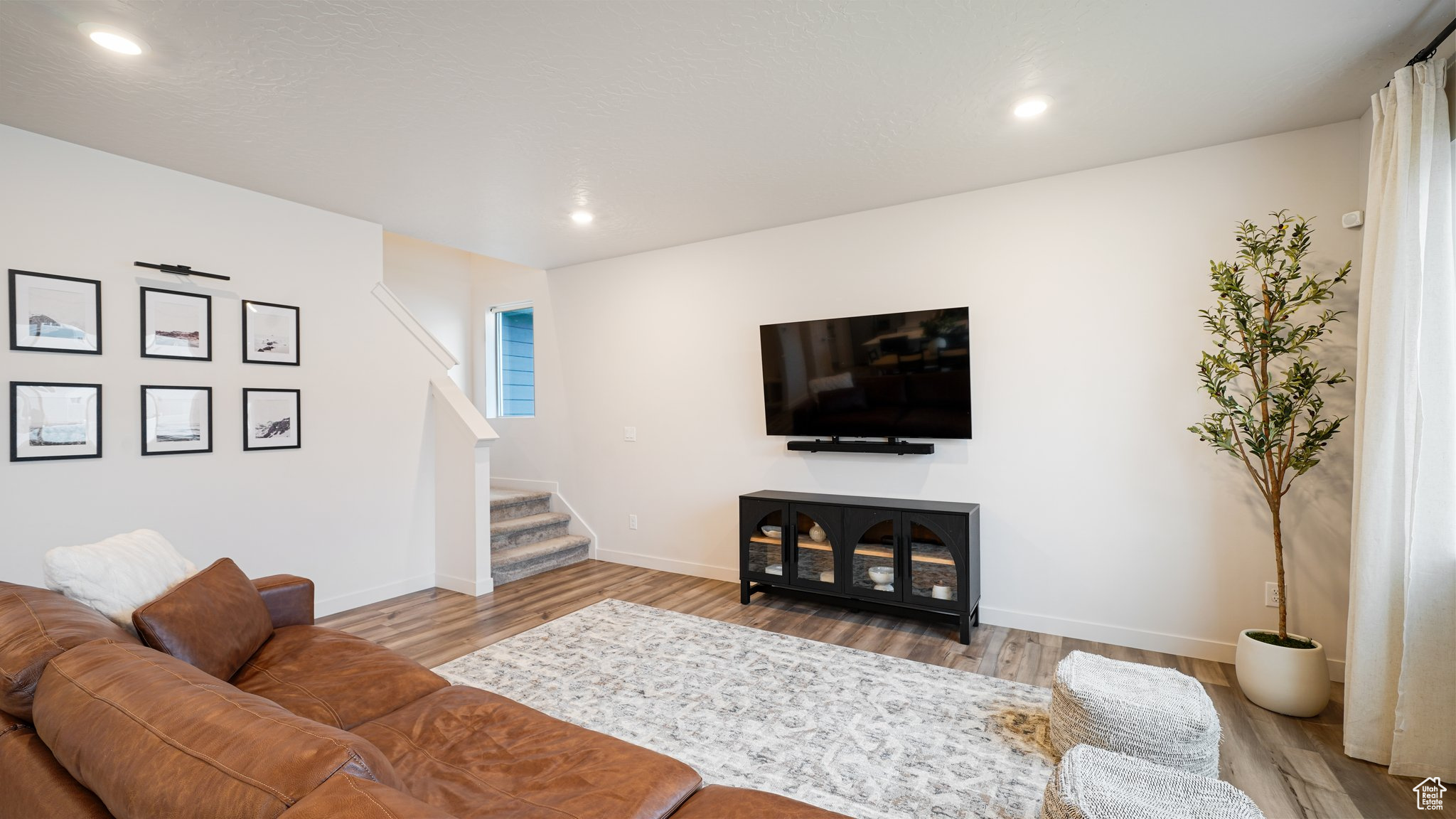 Living room with light hardwood / wood-style flooring