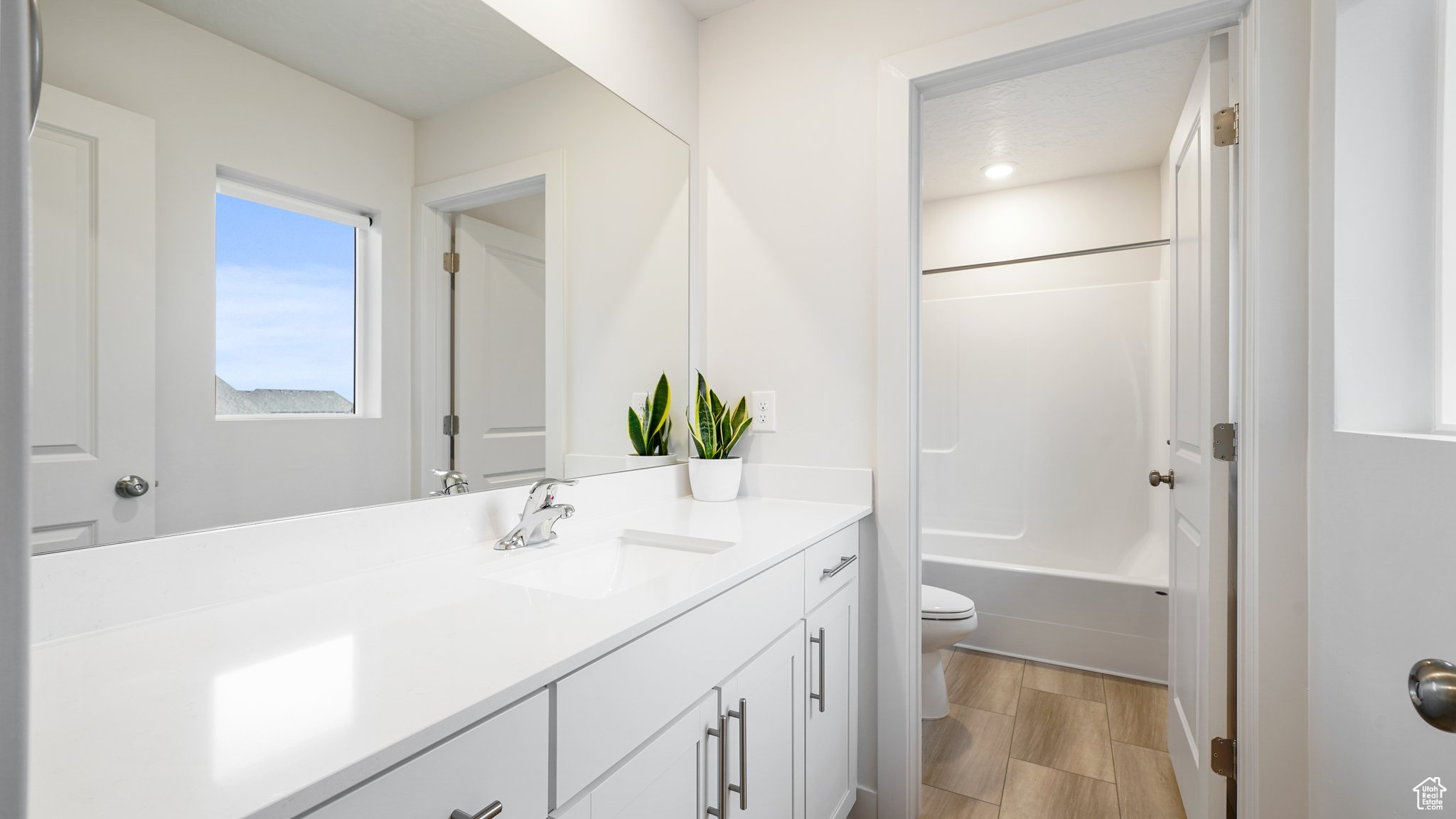 Full bathroom with vanity, bathing tub / shower combination, and toilet