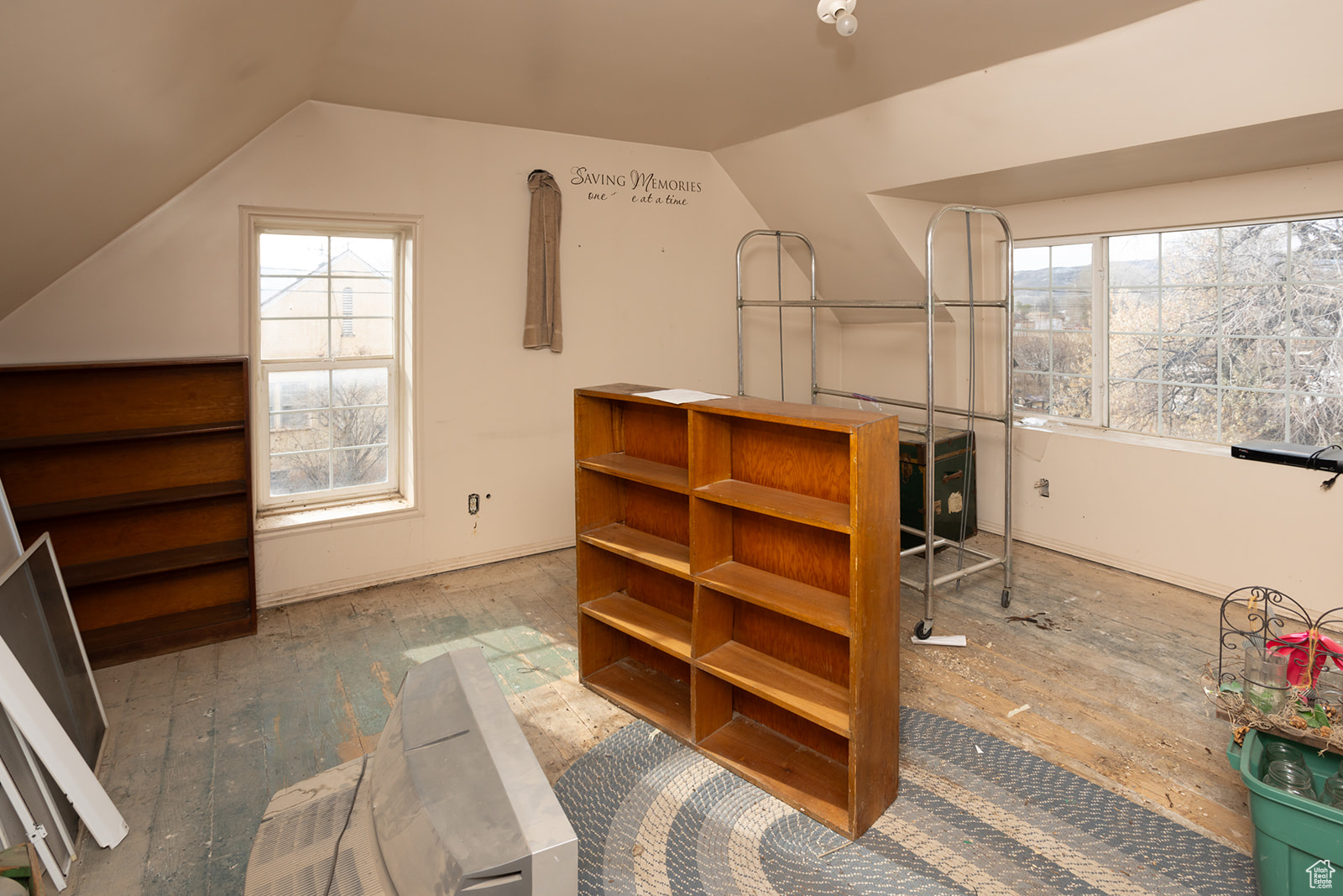 Interior space featuring wood-type flooring and vaulted ceiling