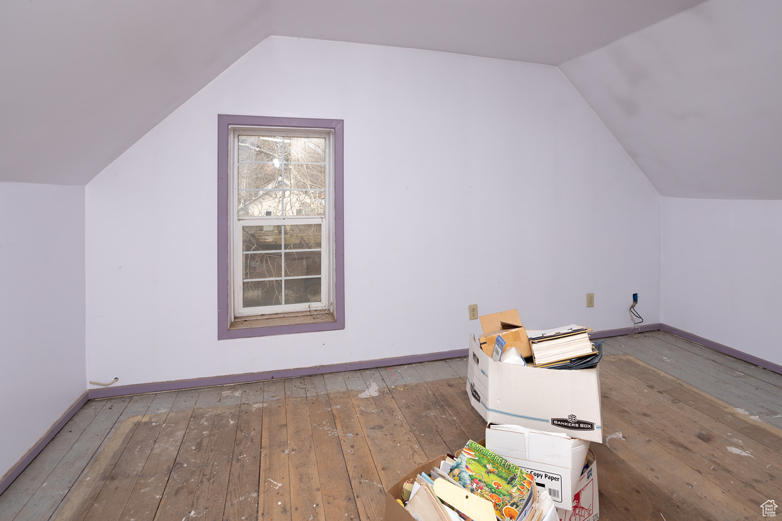 Additional living space featuring hardwood / wood-style floors and lofted ceiling