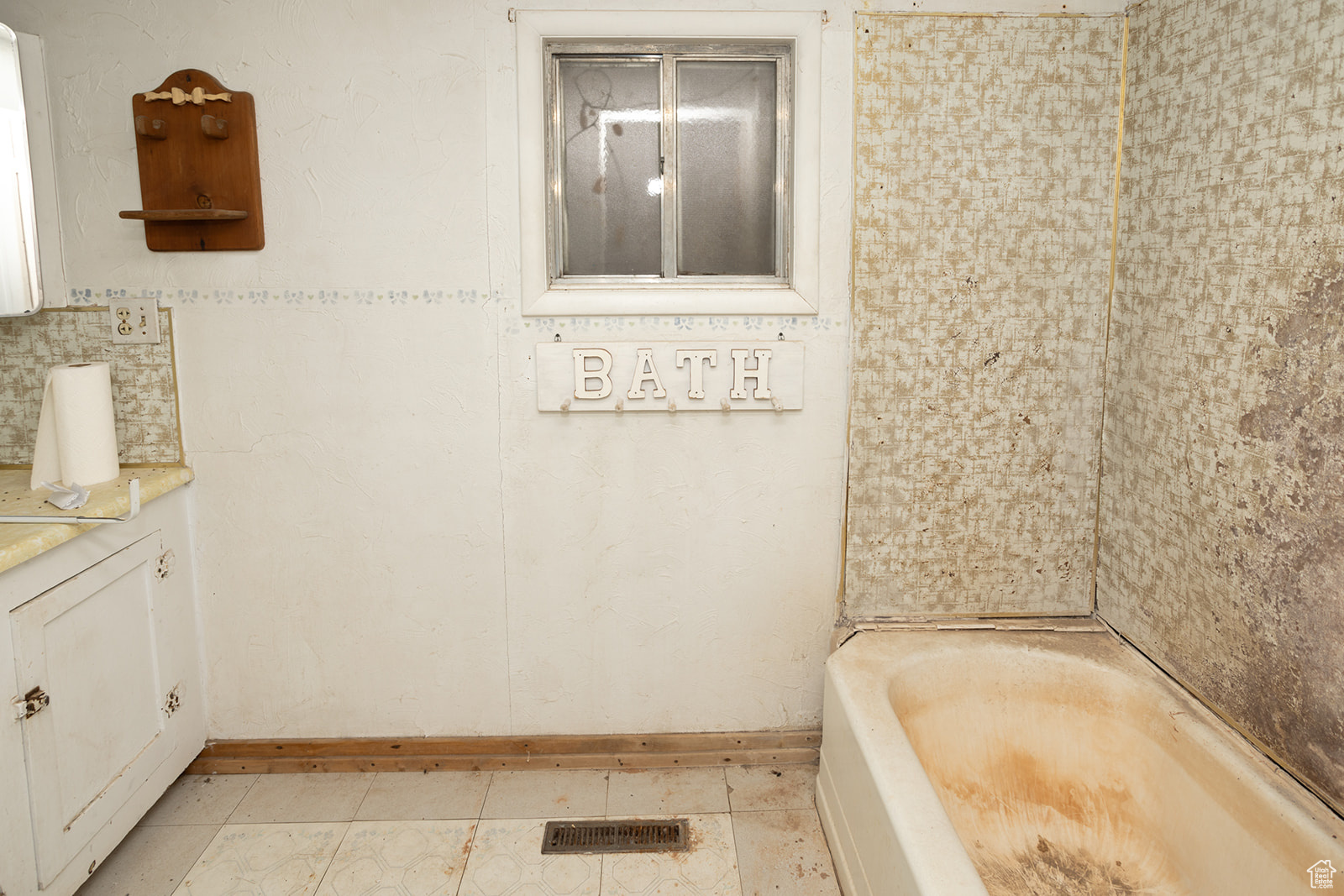 Bathroom featuring tile patterned flooring, vanity, a bath, and tasteful backsplash