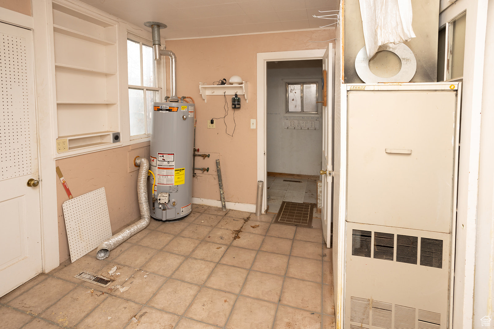 Utility room featuring water heater