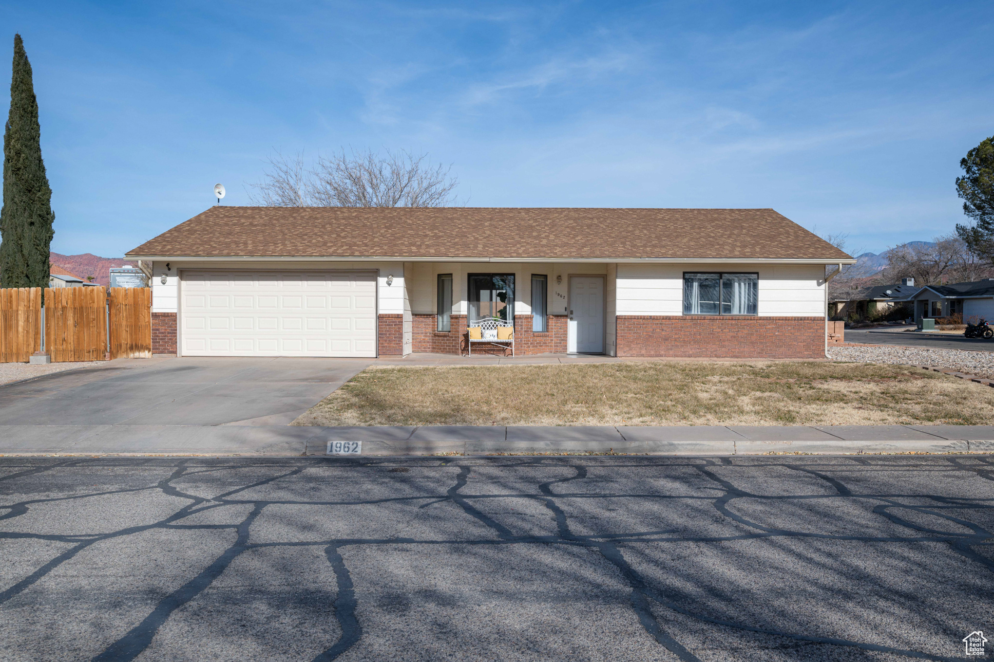 Single story home featuring a porch and a garage