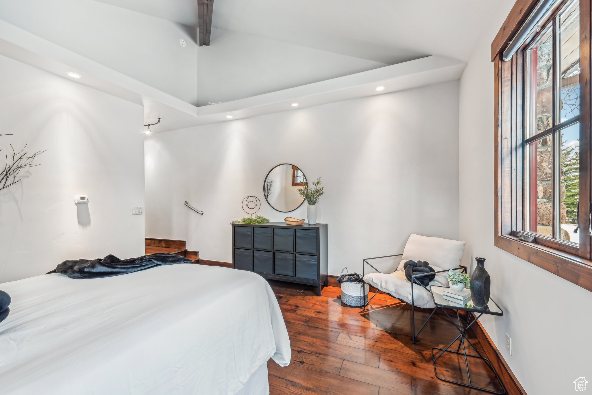 Bedroom featuring vaulted ceiling with beams and wood-type flooring