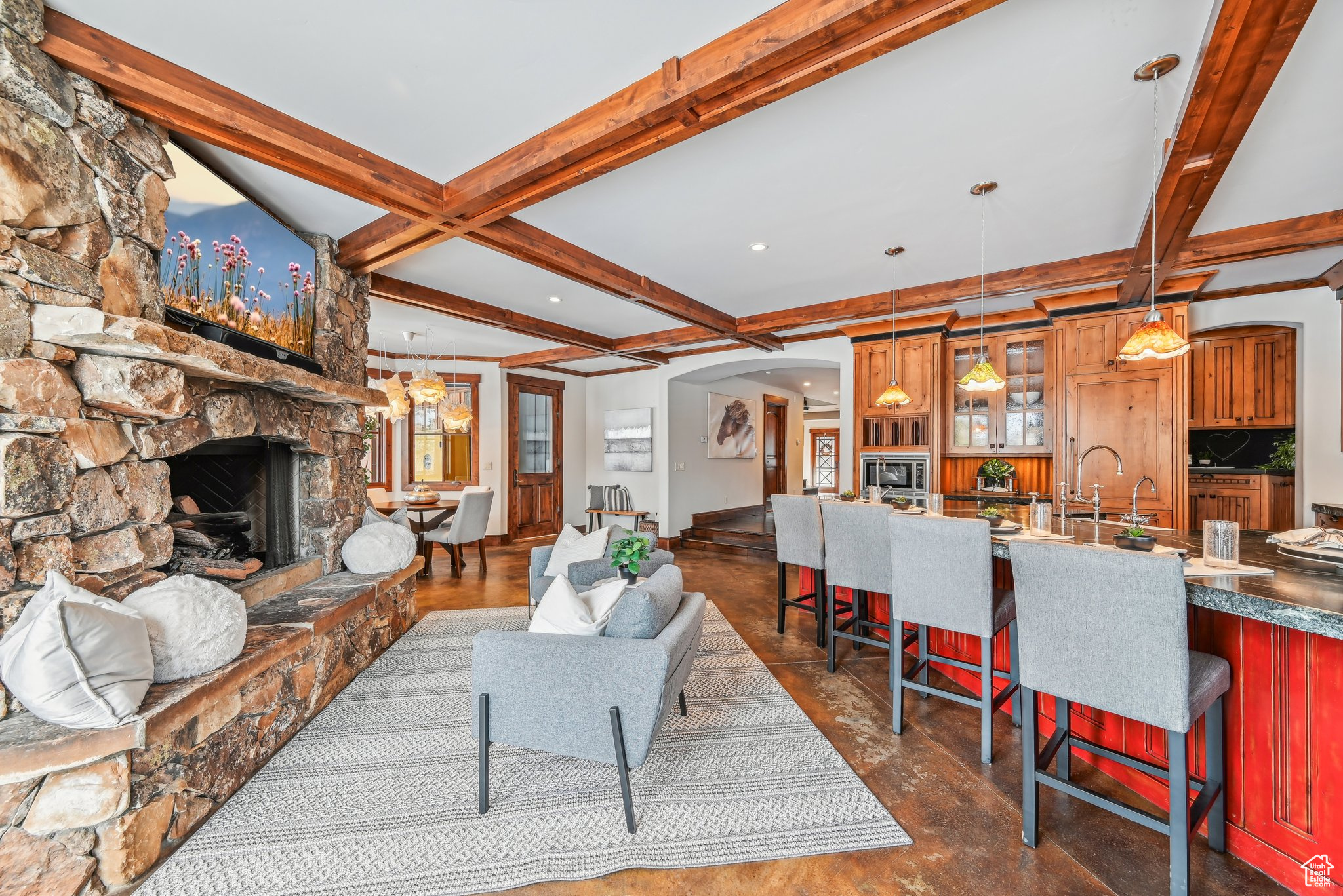 Living room with a fireplace, beam ceiling, dark wood-type flooring, and coffered ceiling