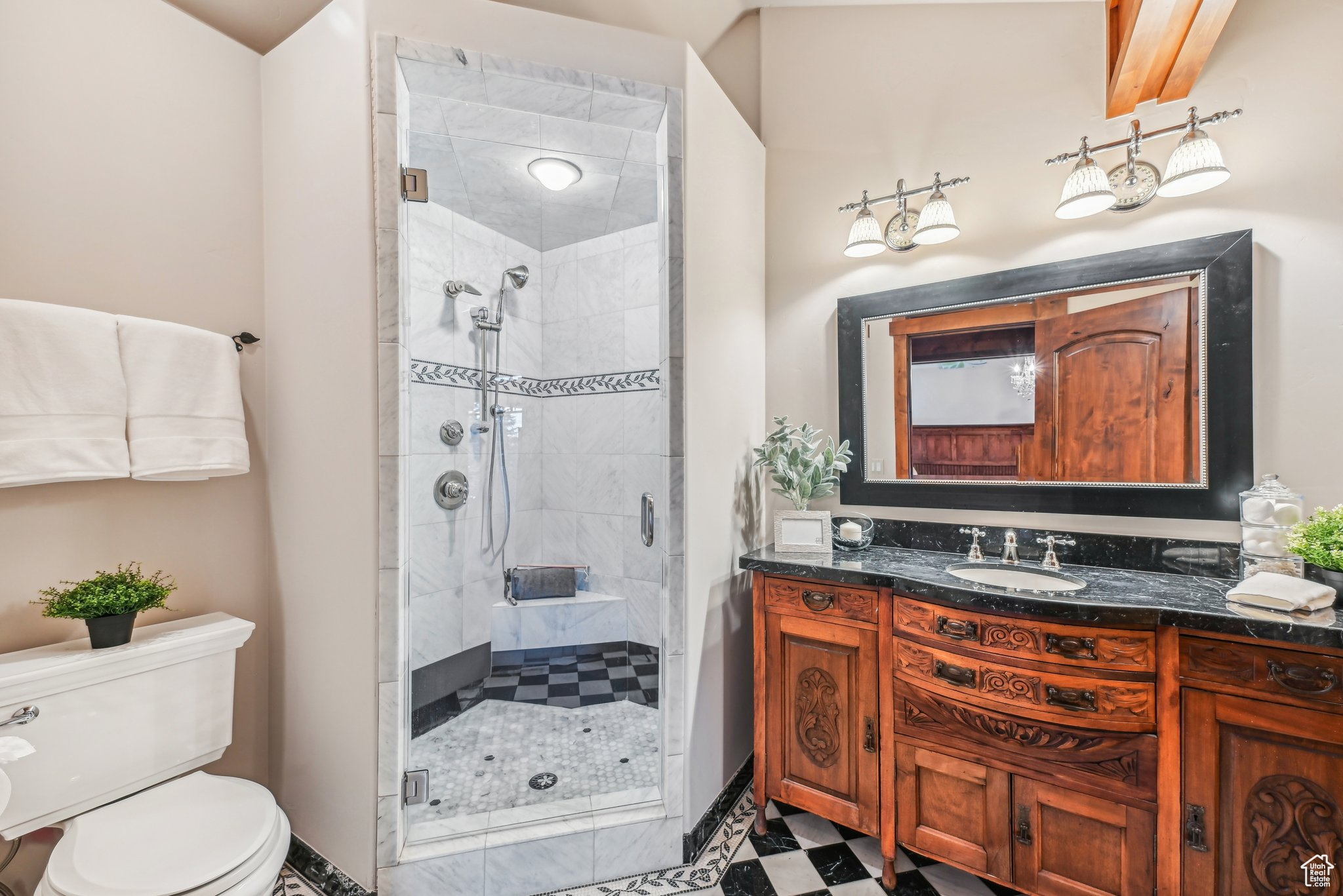 Bathroom with vanity, toilet, and walk in shower