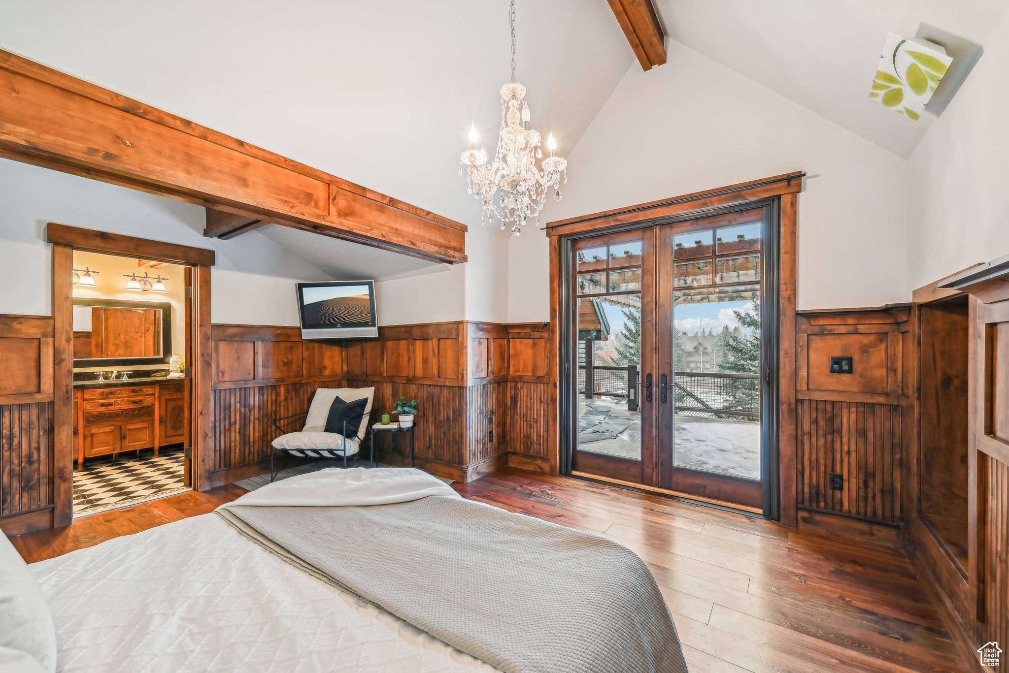 Bedroom featuring french doors, vaulted ceiling with beams, a notable chandelier, wood-type flooring, and access to outside