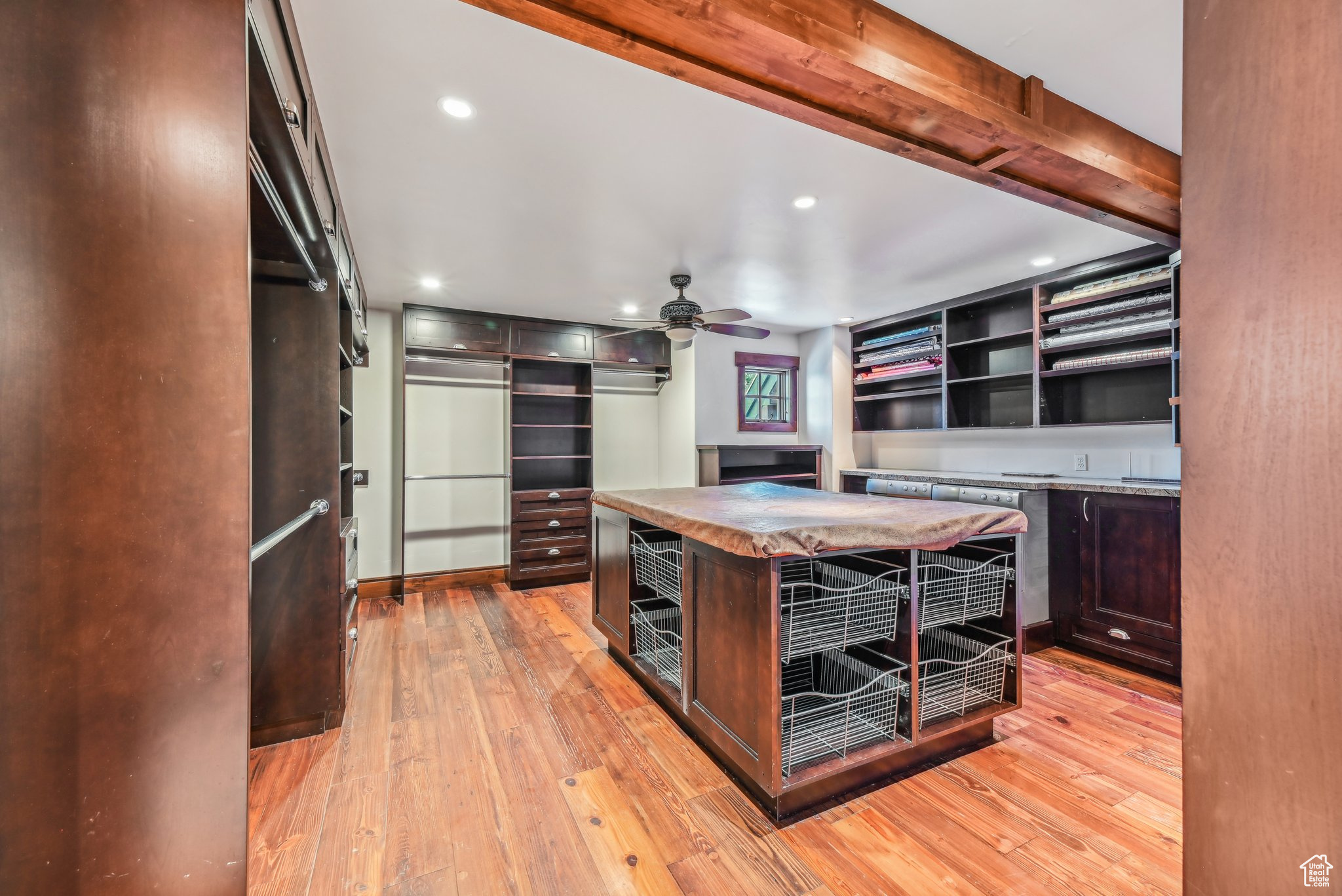 Kitchen with dark brown cabinetry, a center island, light hardwood / wood-style flooring, and ceiling fan