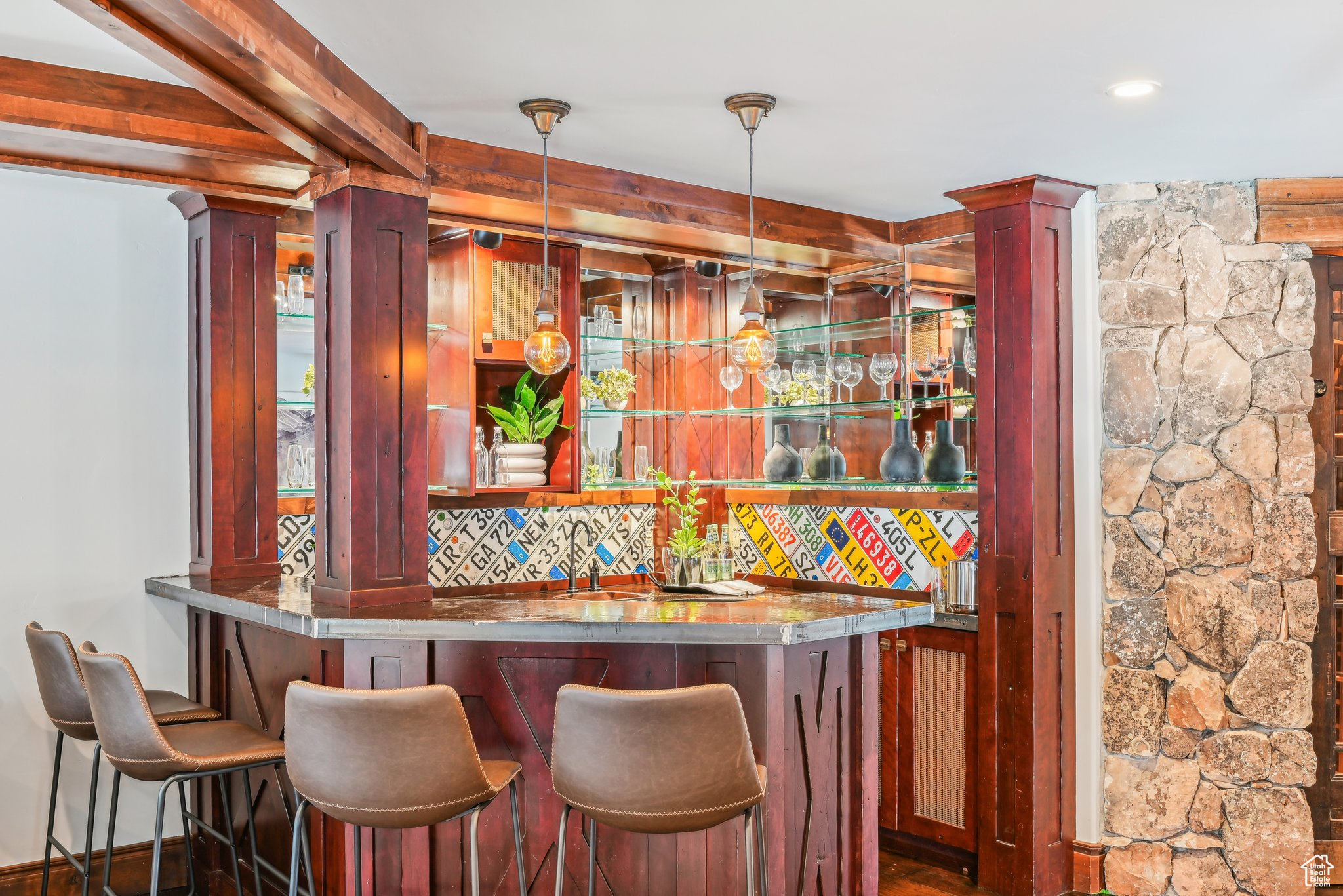 Bar with decorative backsplash and pendant lighting